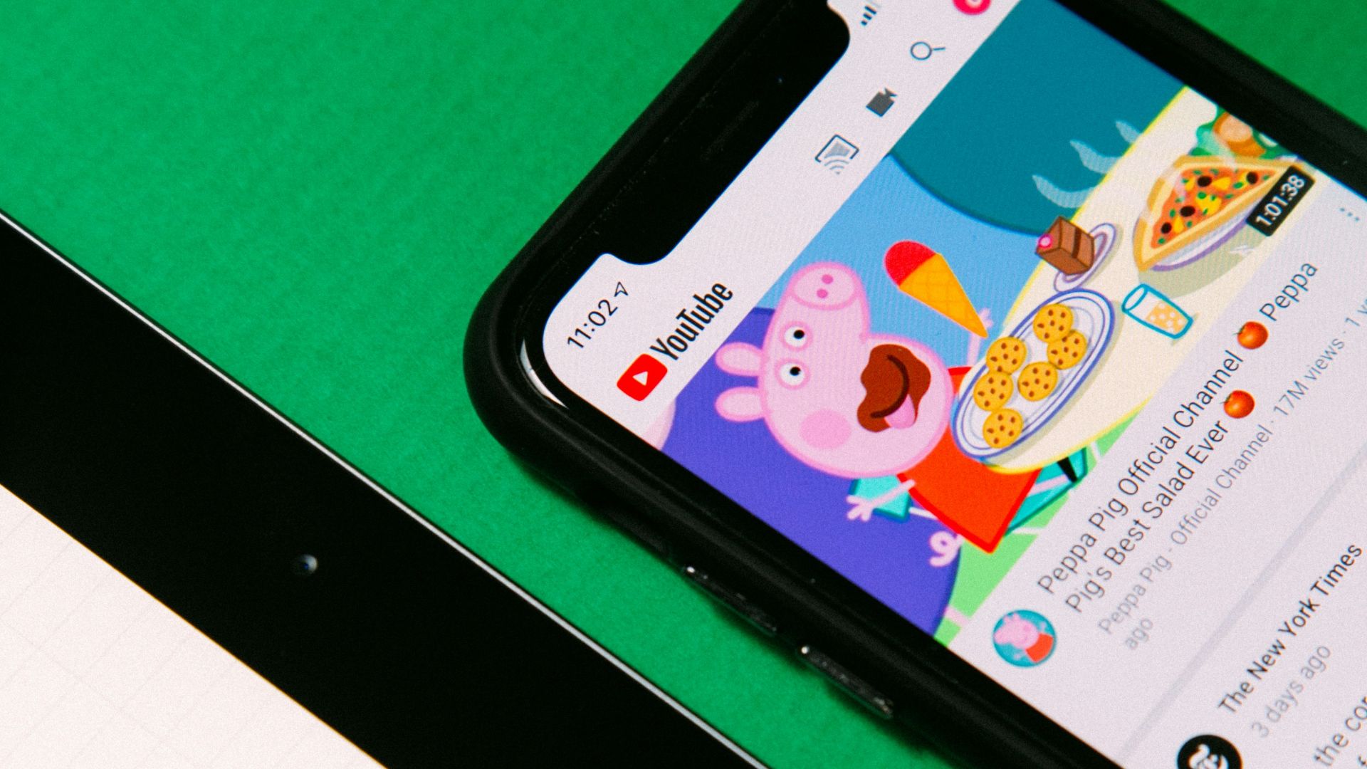 black android smartphone on green table