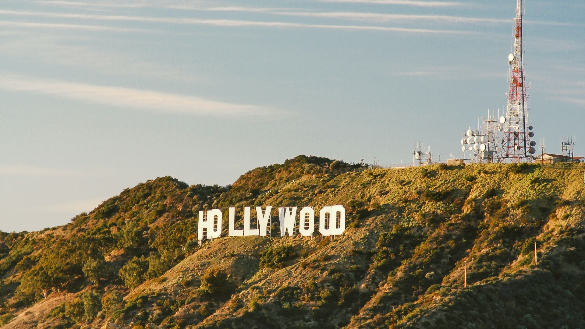white and red tower on top of green mountain
