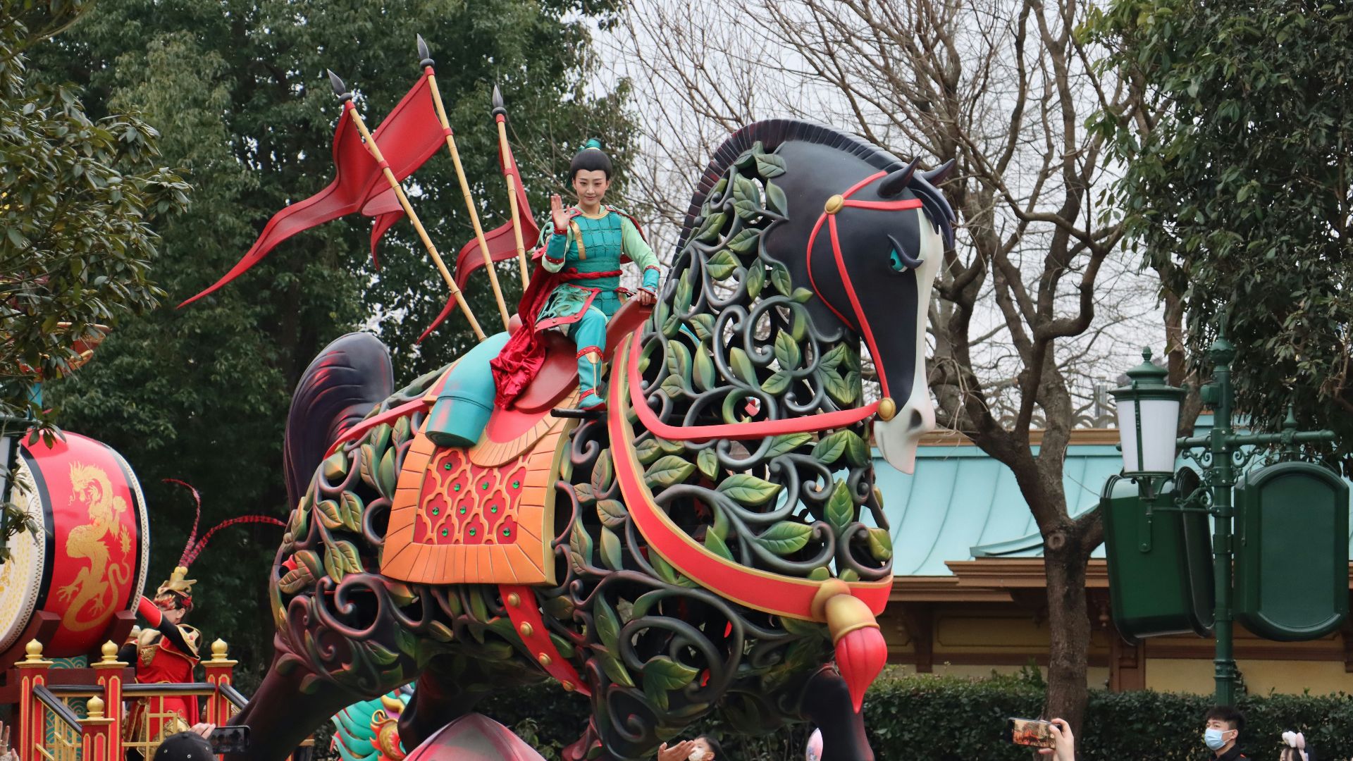 a woman riding on the back of a decorated elephant