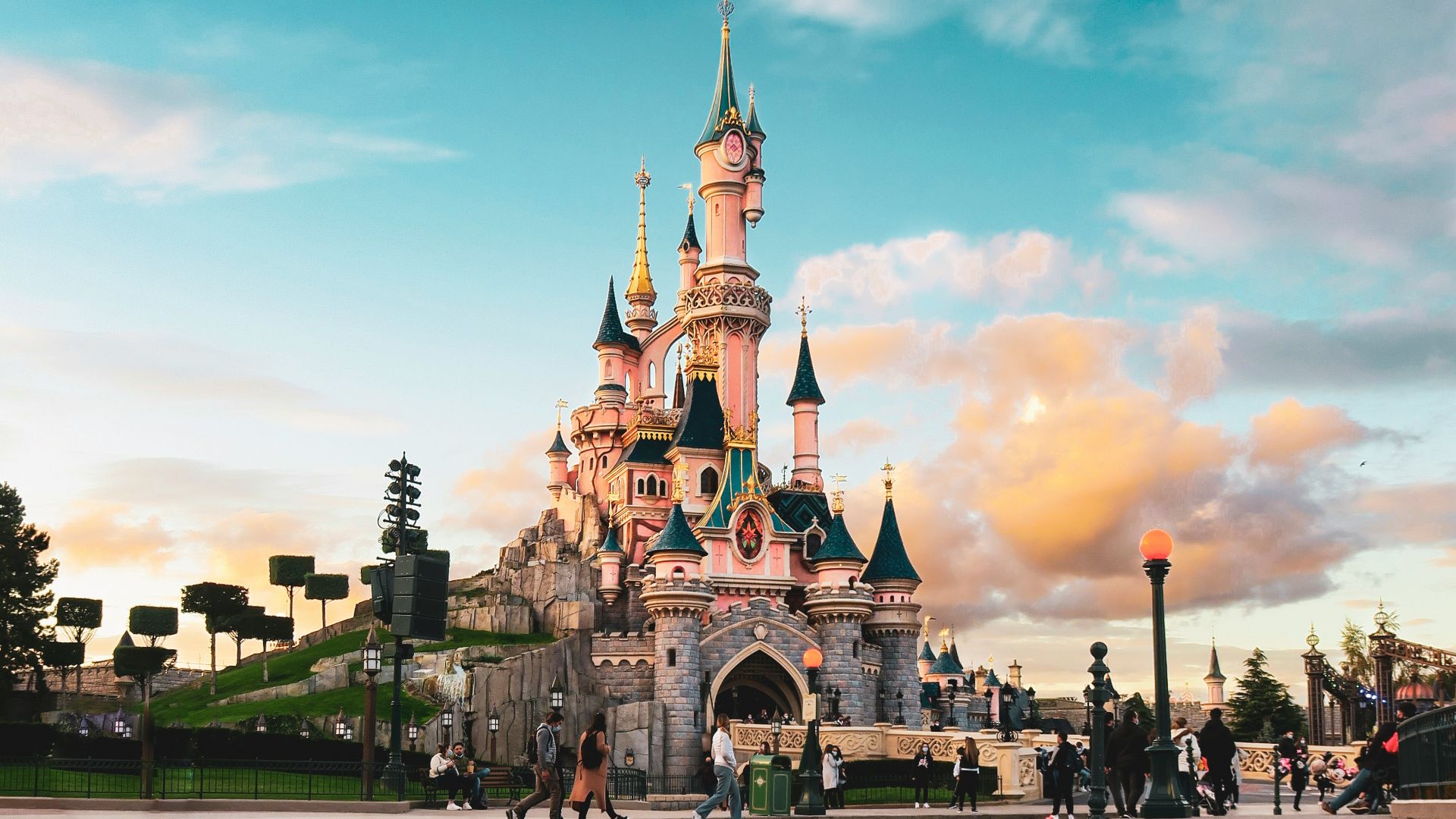 people walking on sidewalk near brown concrete building during daytime