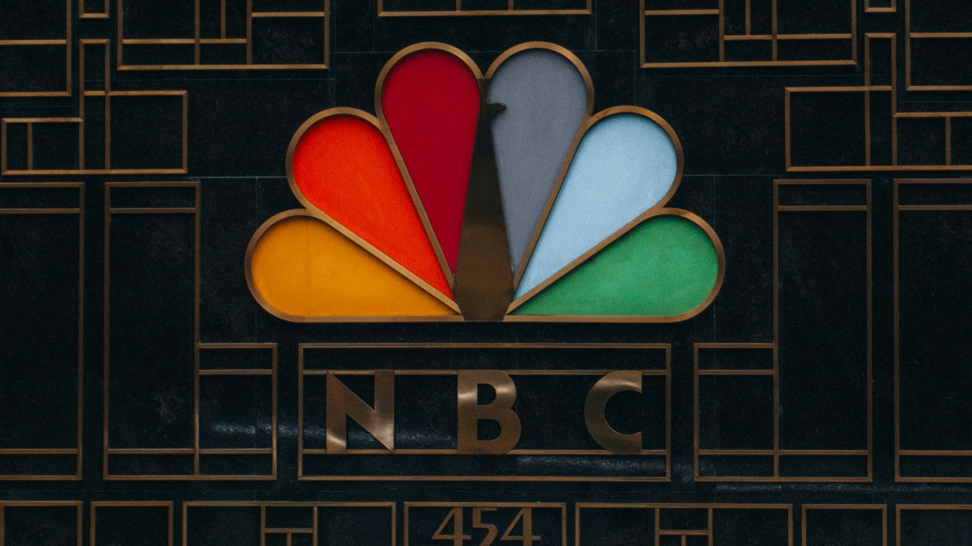 a tall building with a colorful logo on it