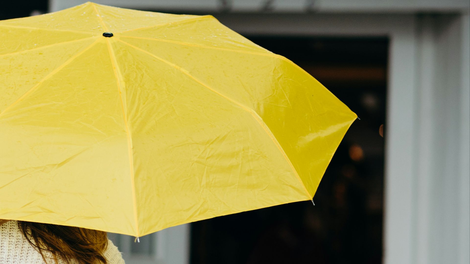 woman using yellow umbrella