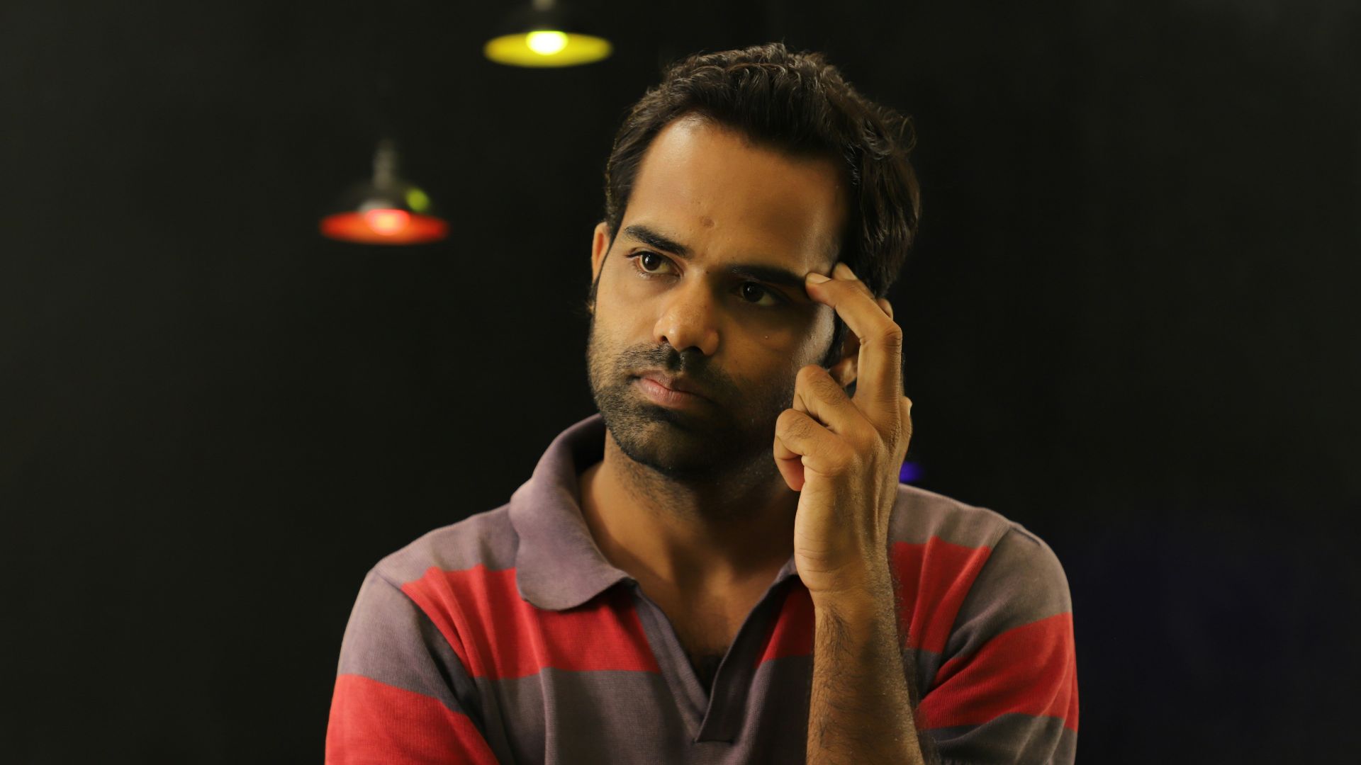 man in red and gray v neck shirt wearing black sunglasses