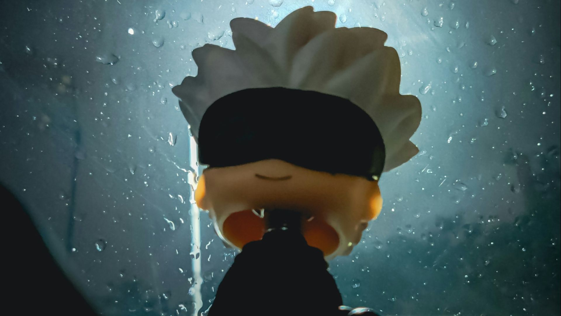 A person with a blindfolded head standing in front of a window