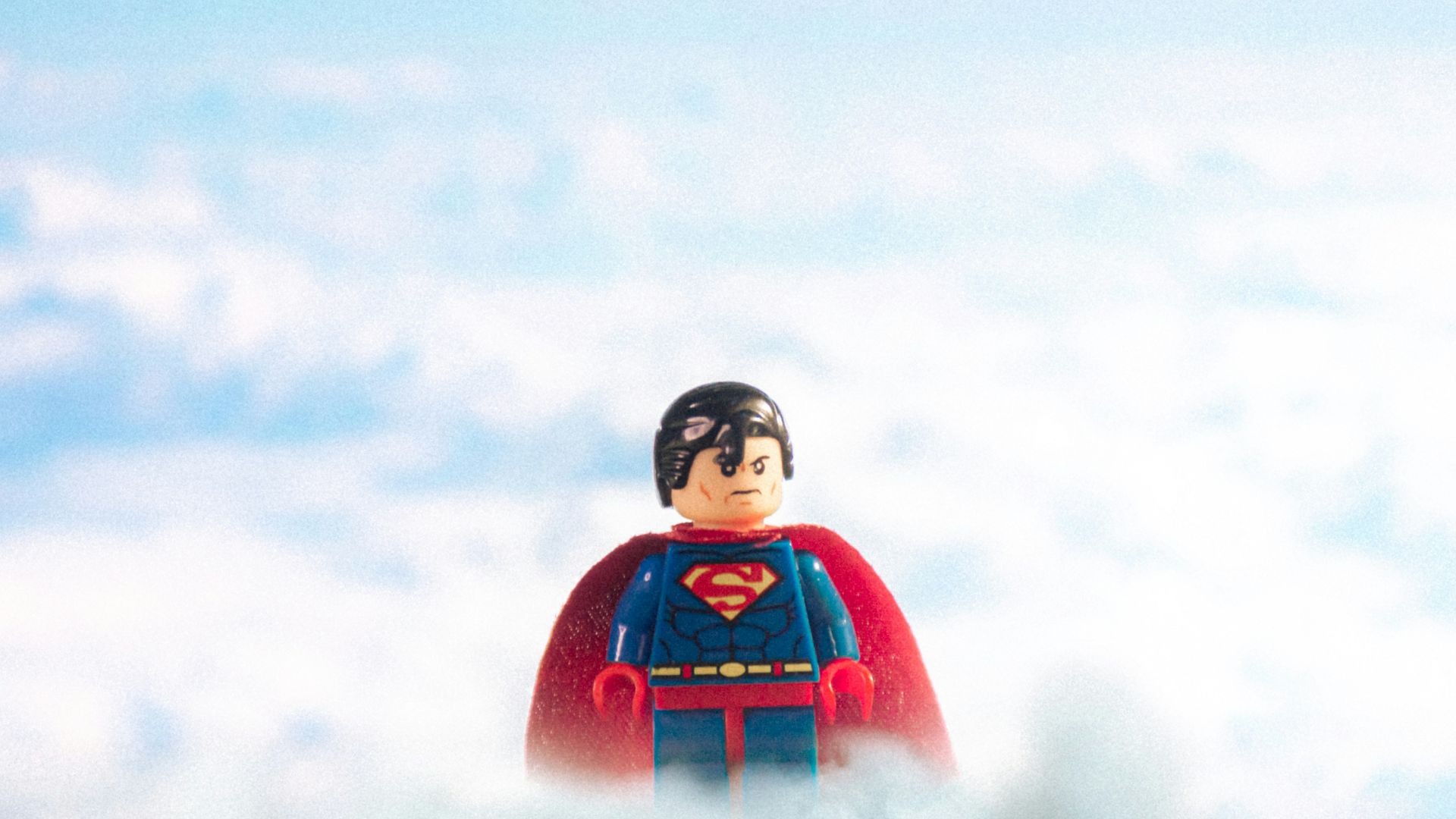 man in red and black jacket standing on snow covered ground during daytime