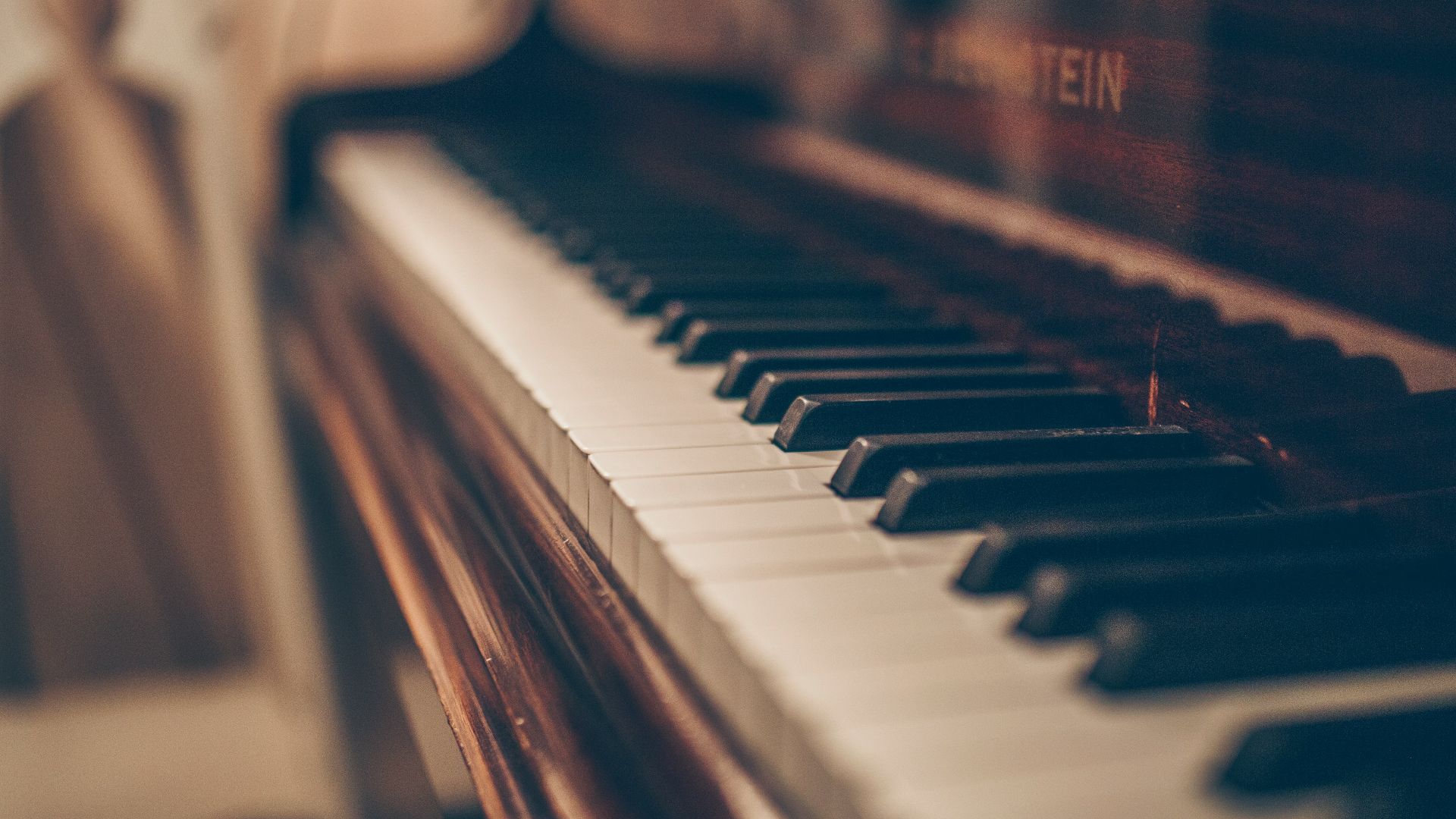 a close up of a piano with a person in the background