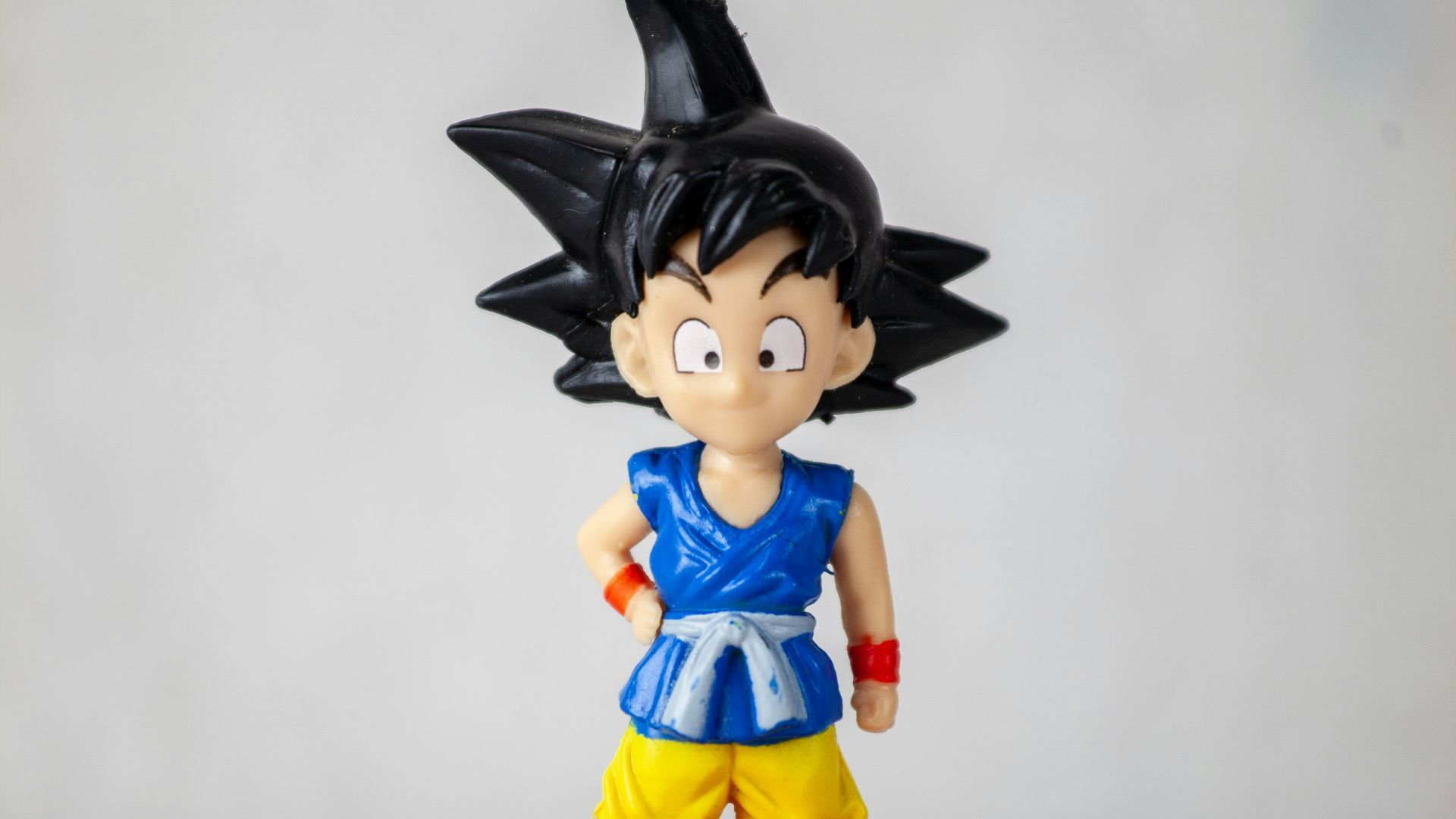 a toy figurine of a girl wearing a hat and a blue shirt