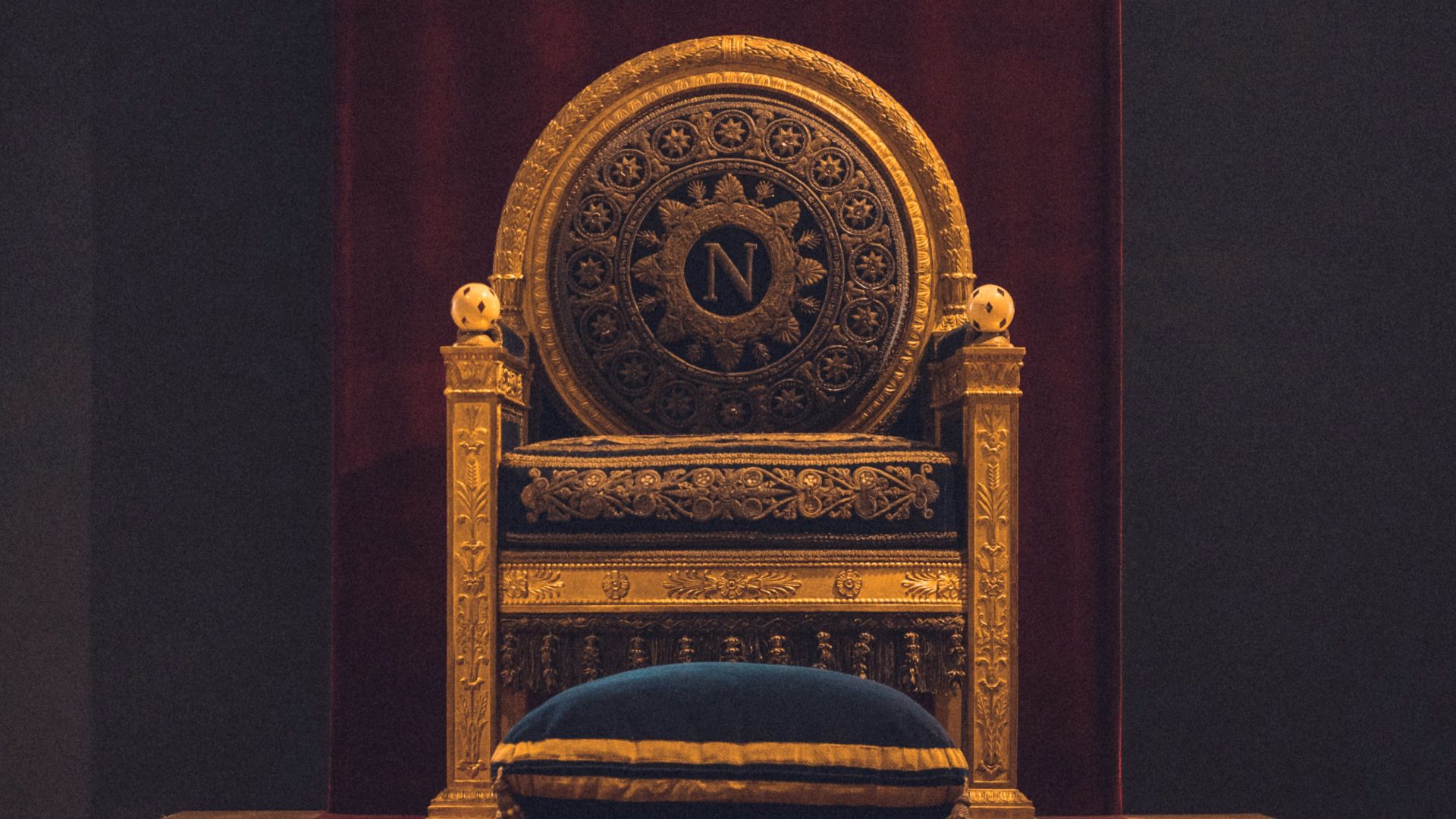 gray and black wooden chair with fabric cushion