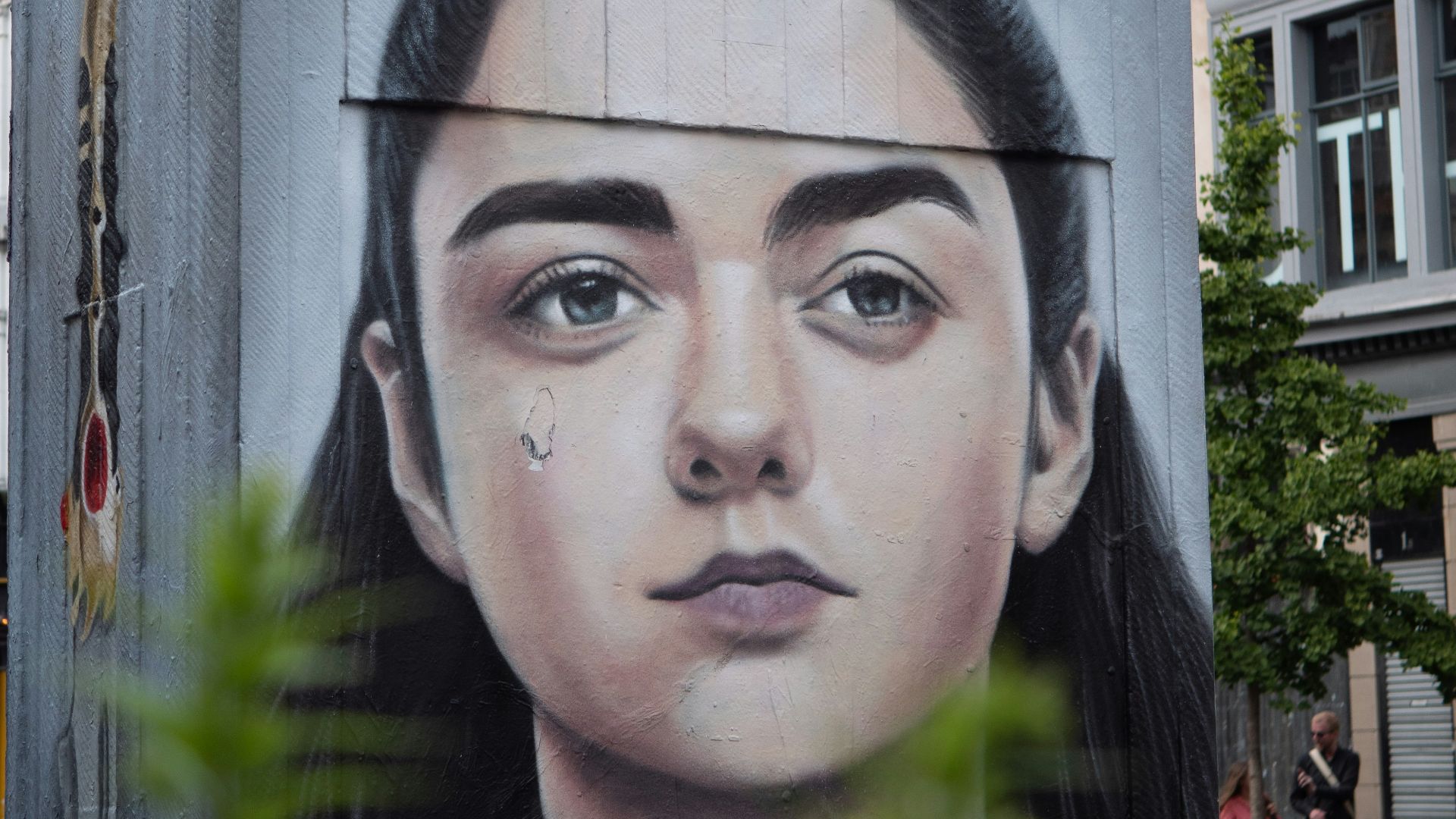 man in black shirt standing near building