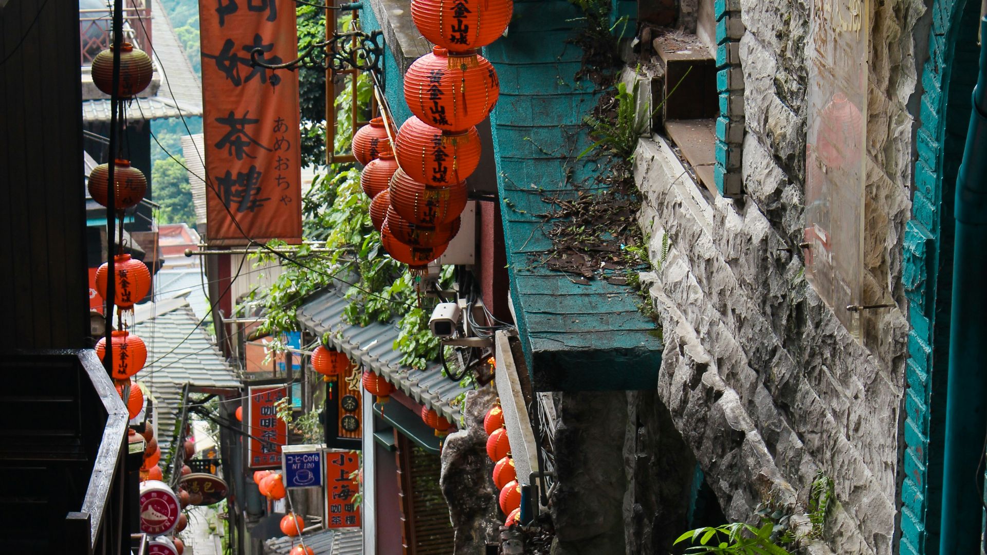 red and brown hanging decors on green concrete wall during daytime