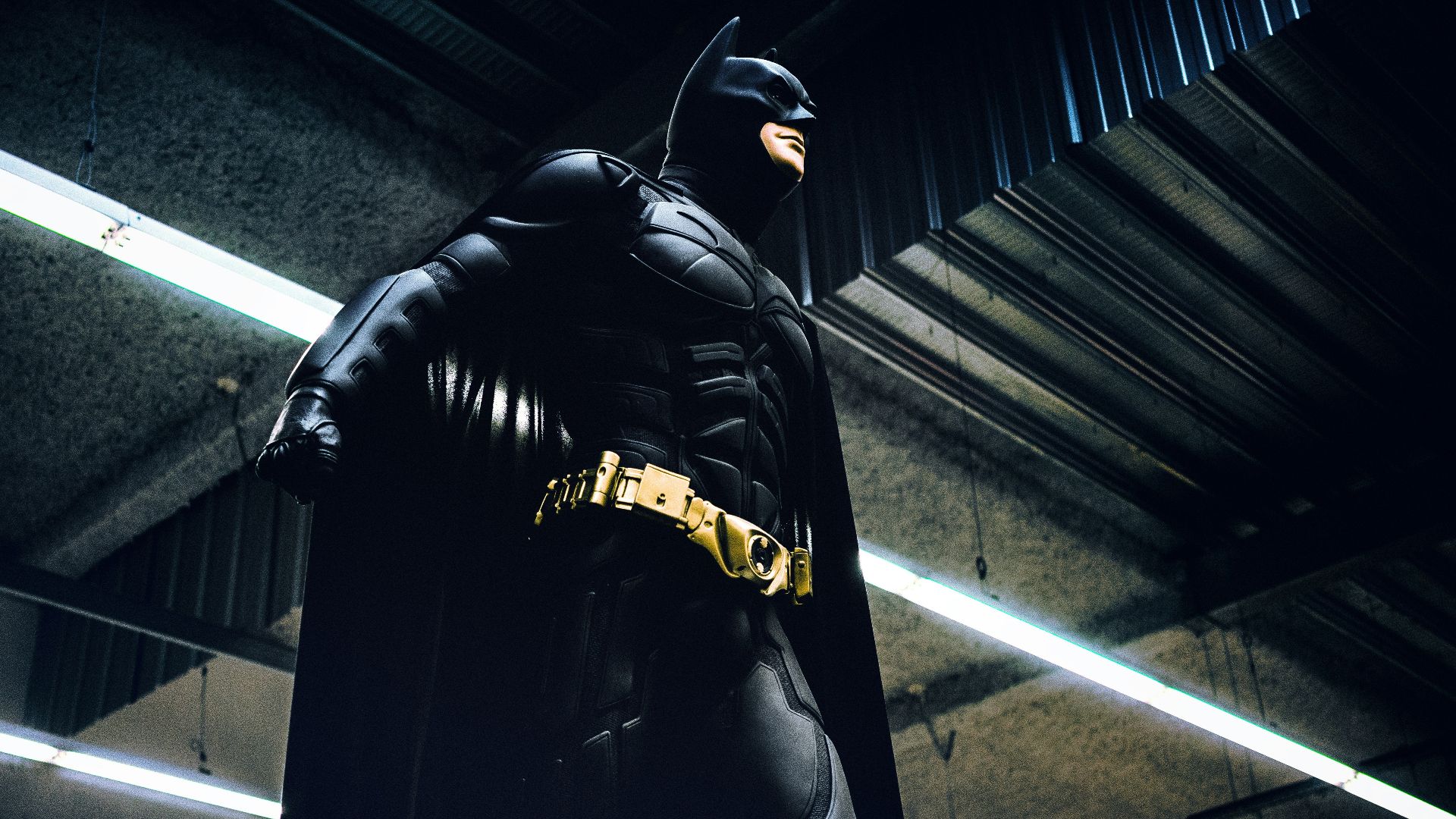 Batman standing under steel roof