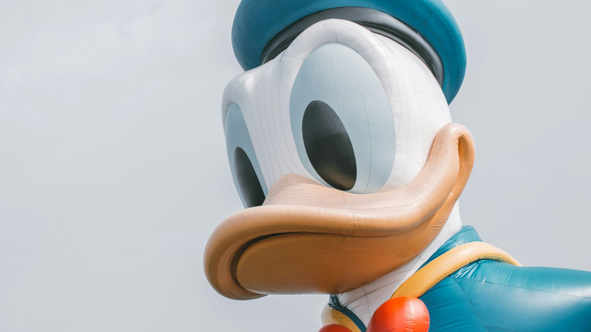 a large mickey mouse balloon with a bow tie