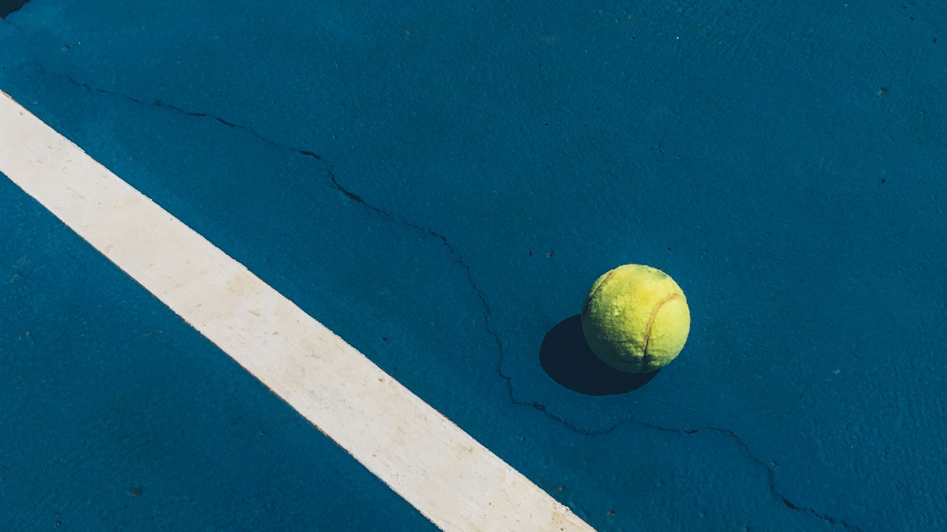 yellow tennis ball on court
