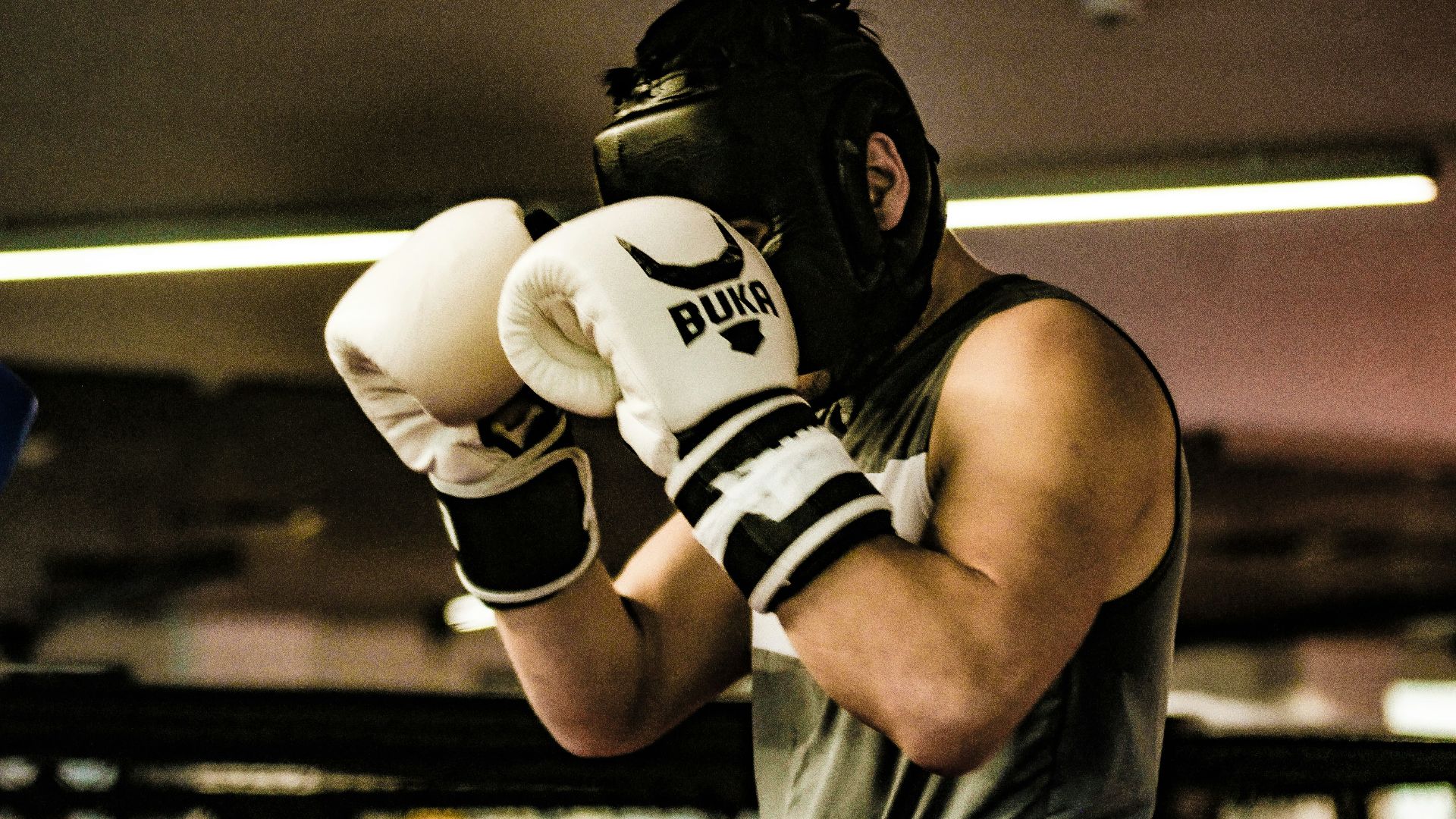a man wearing a white and black boxing glove