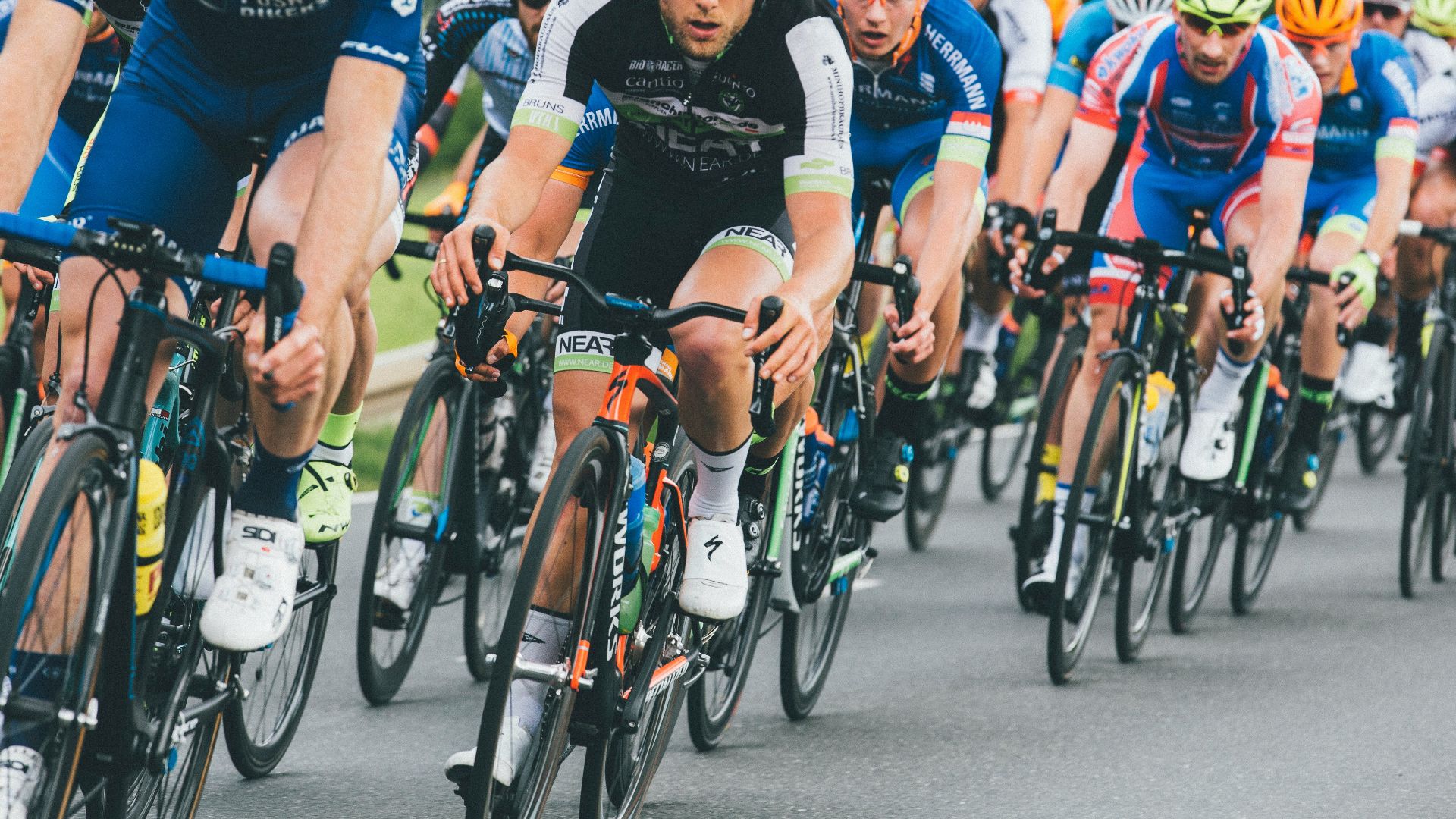 group of cyclist on asphalt road