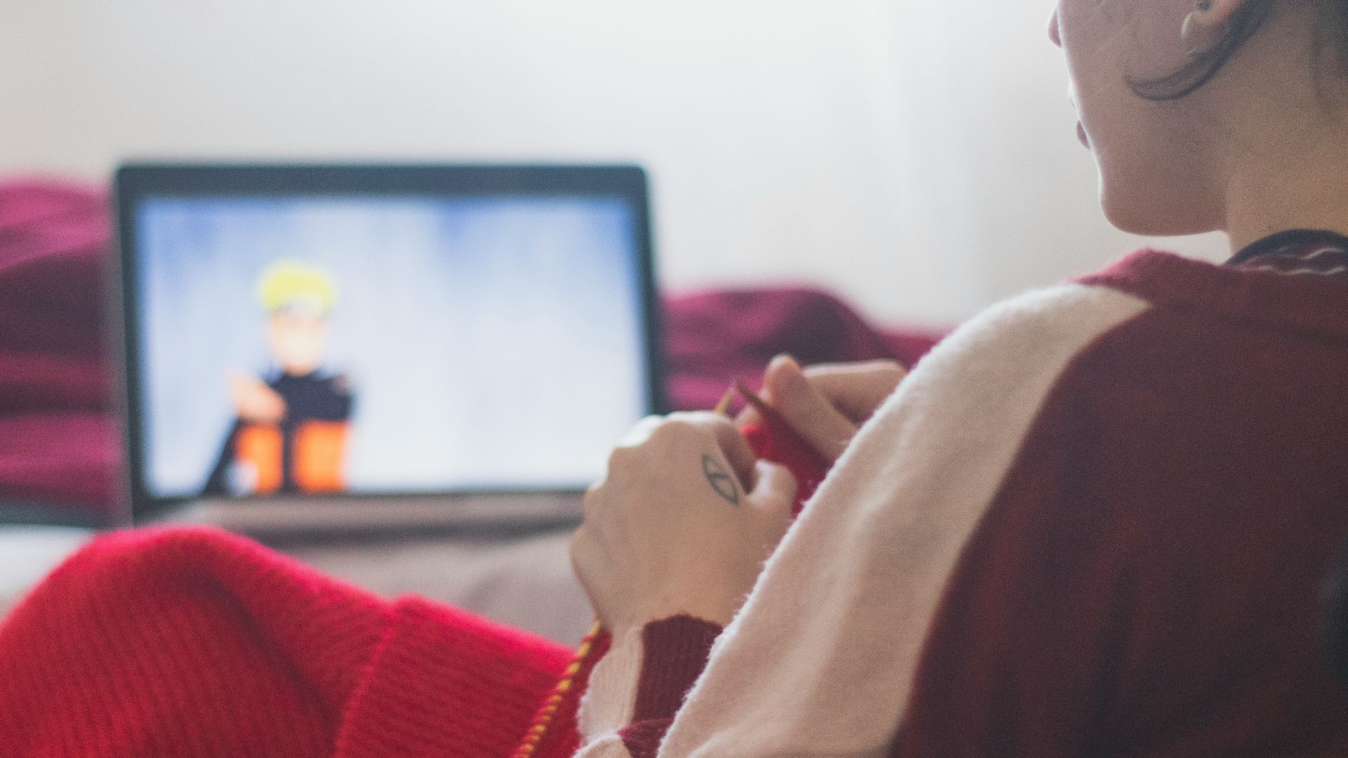 woman in red sweater sitting on chair