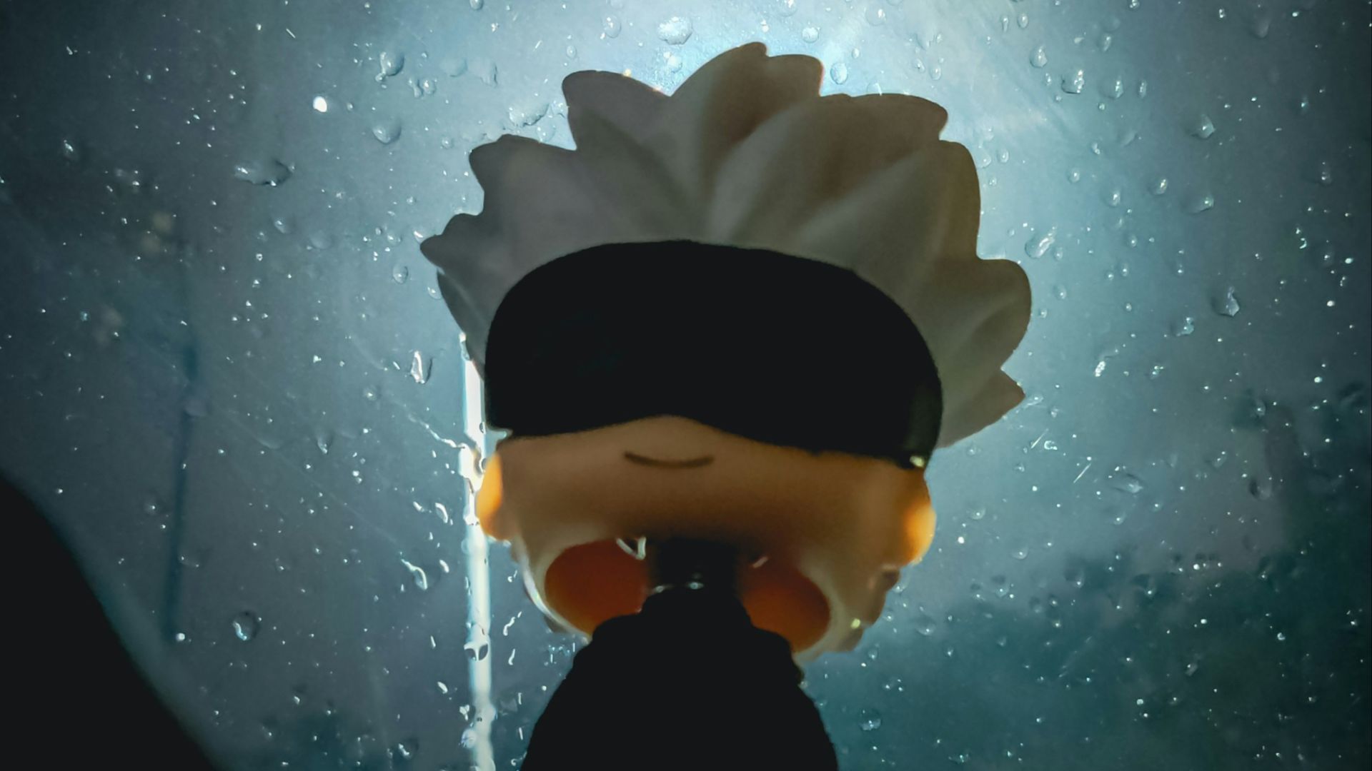 A person with a blindfolded head standing in front of a window