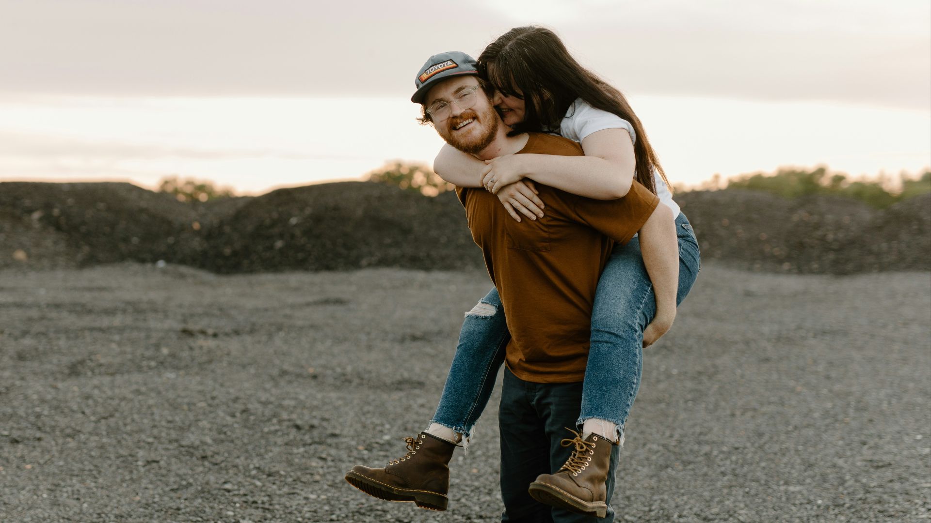 a man carrying a woman on his back