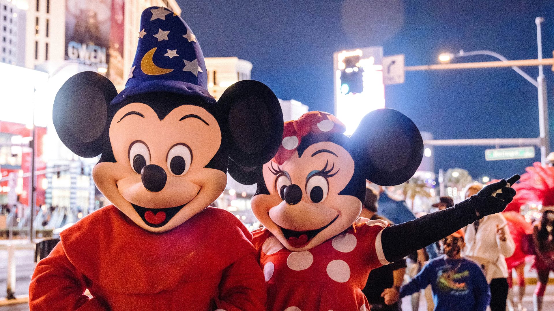 mickey mouse mascot standing near people in mickey mouse costume