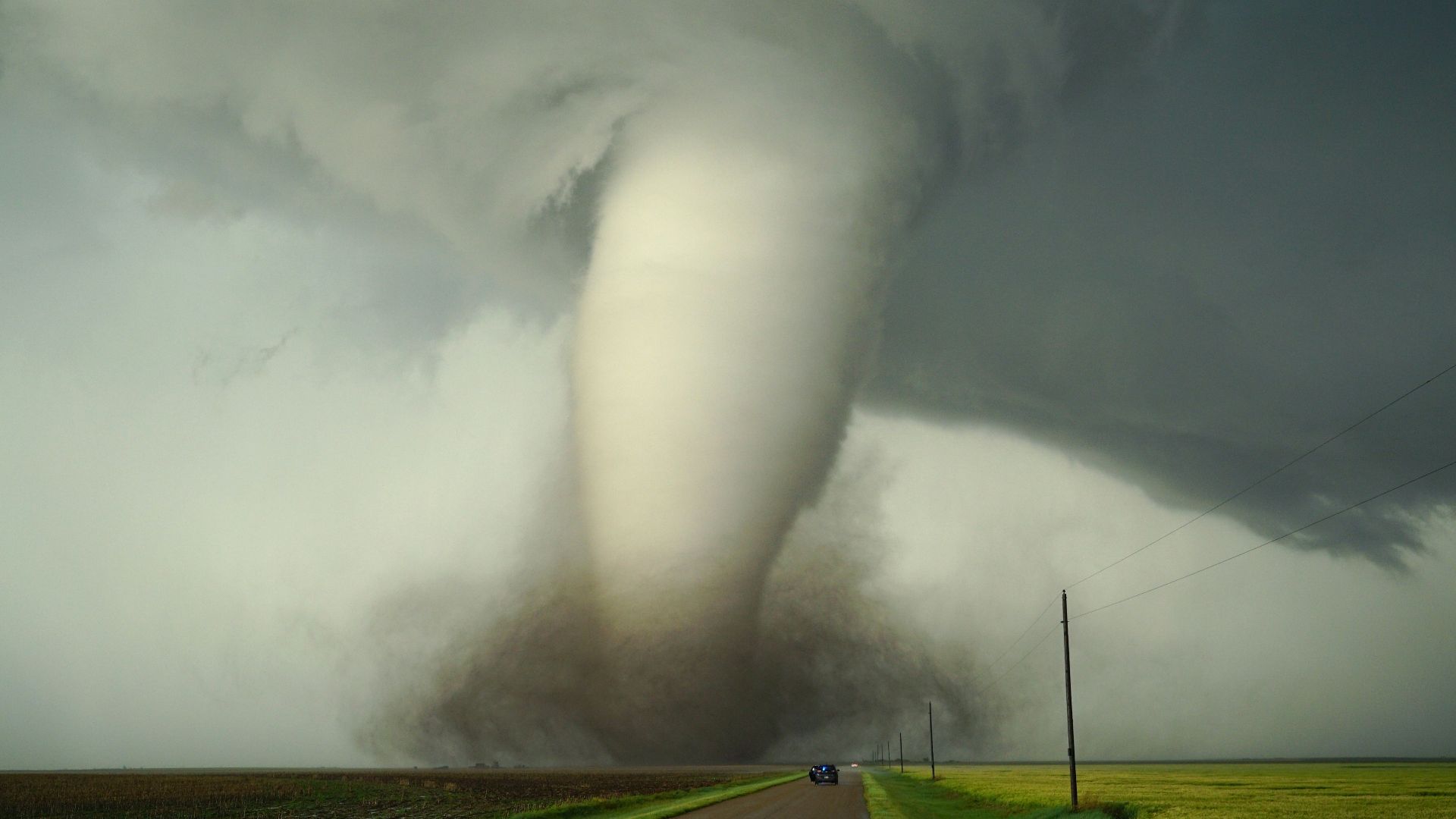 a large tornado is coming down the road