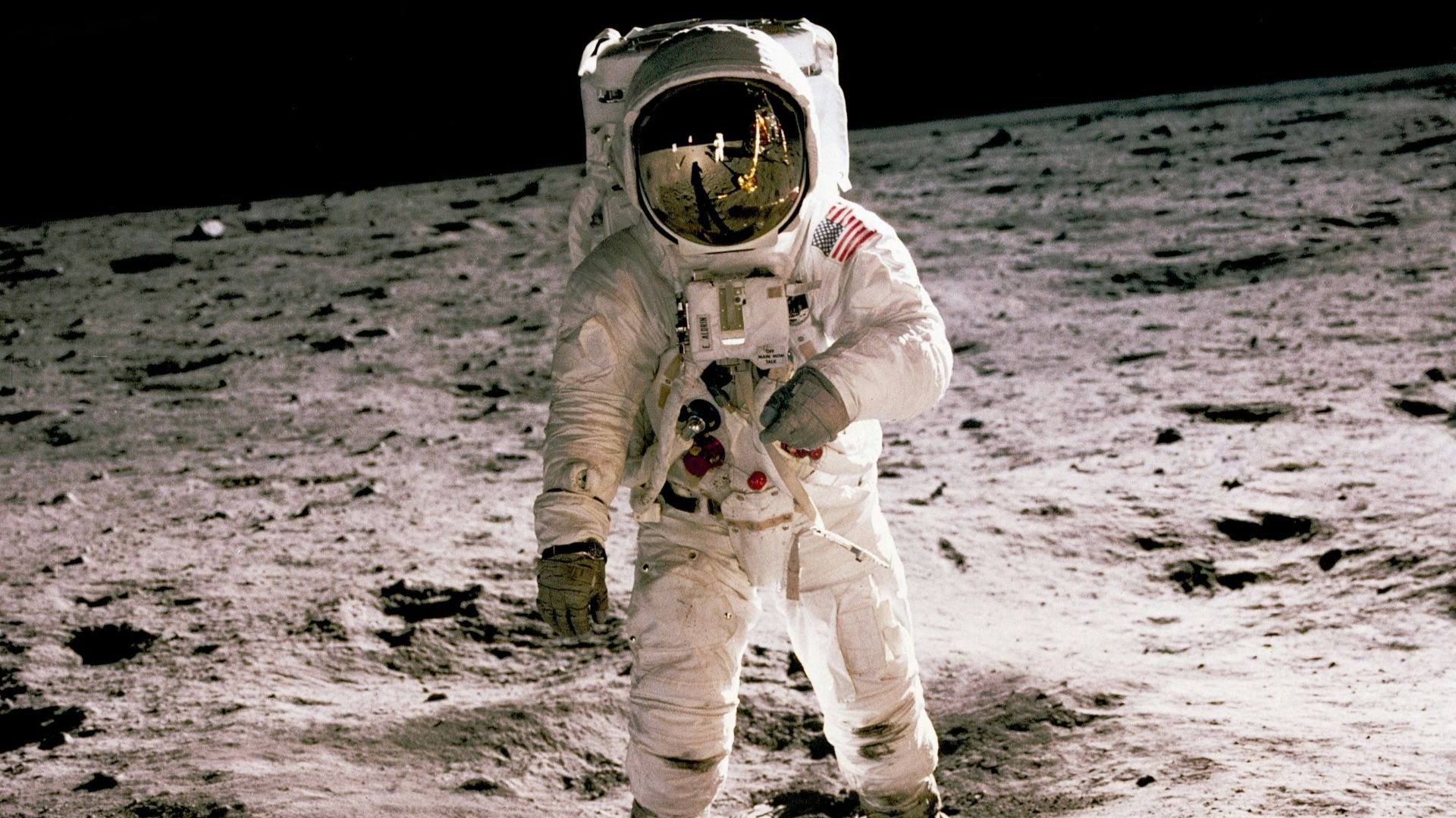 astronaut standing on gray sand