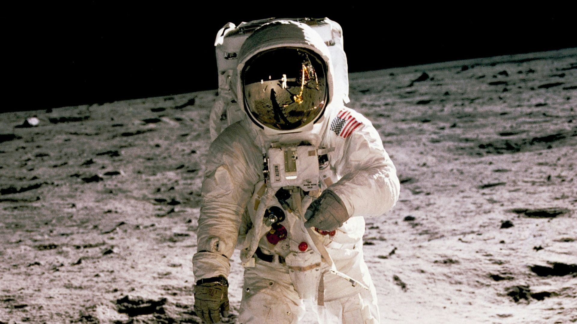 astronaut standing on gray sand