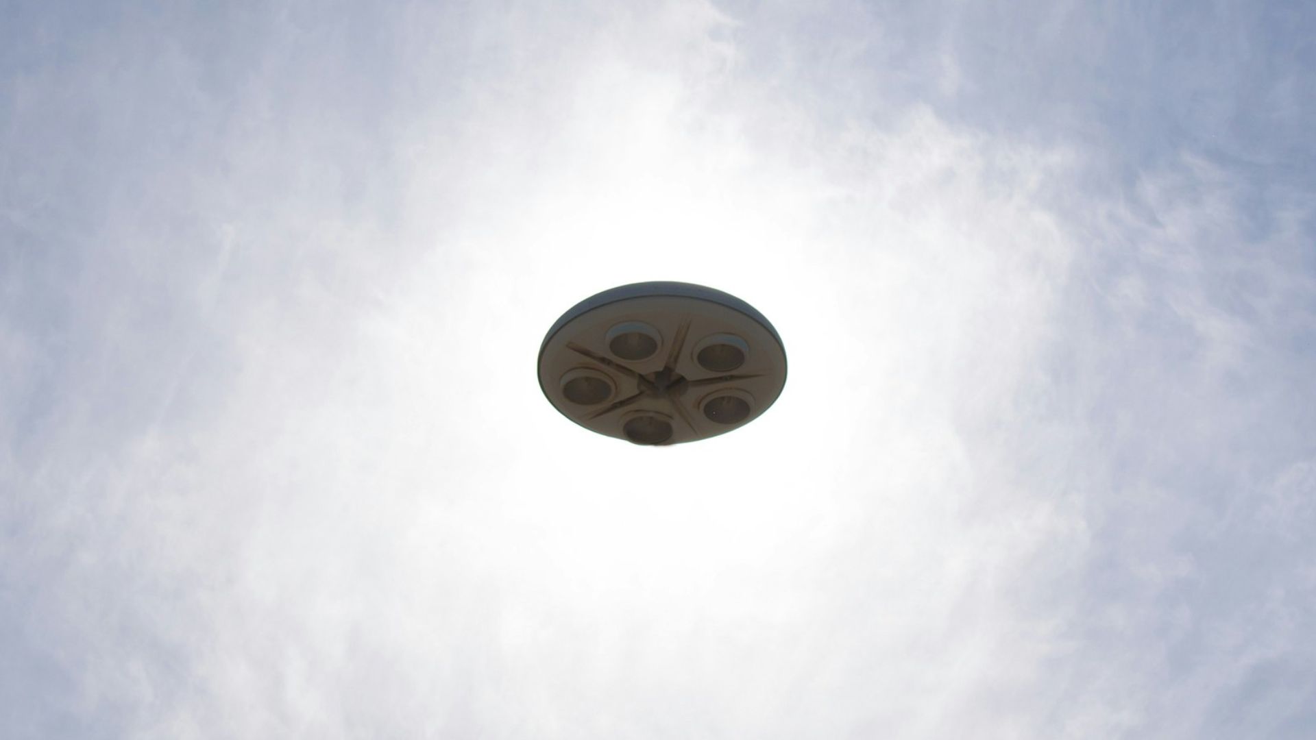 a frisbee flying through the air with a blue sky in the background