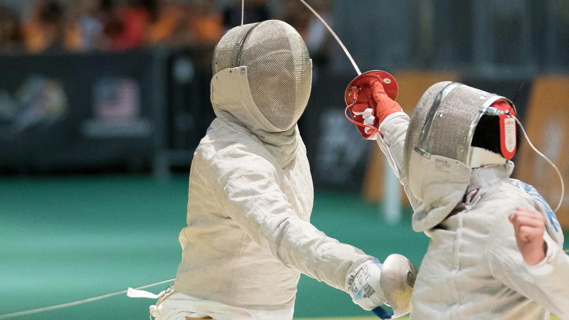 two person fencing inside the gym