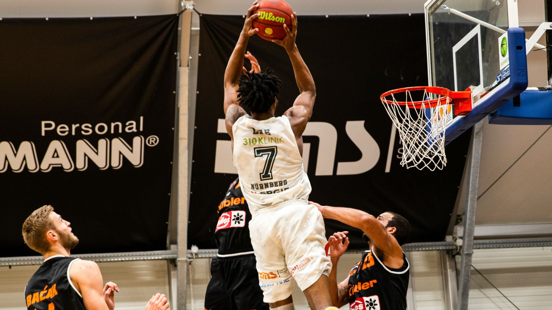 people playing basketball inside court