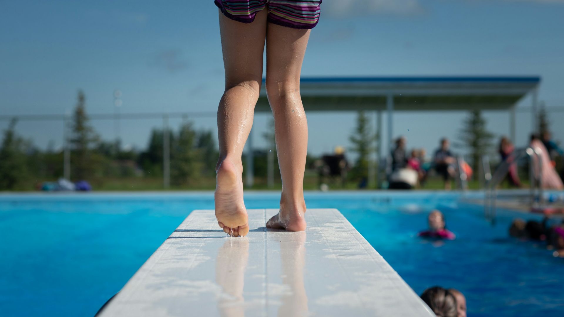 woman in black and pink shorts standing on white floor