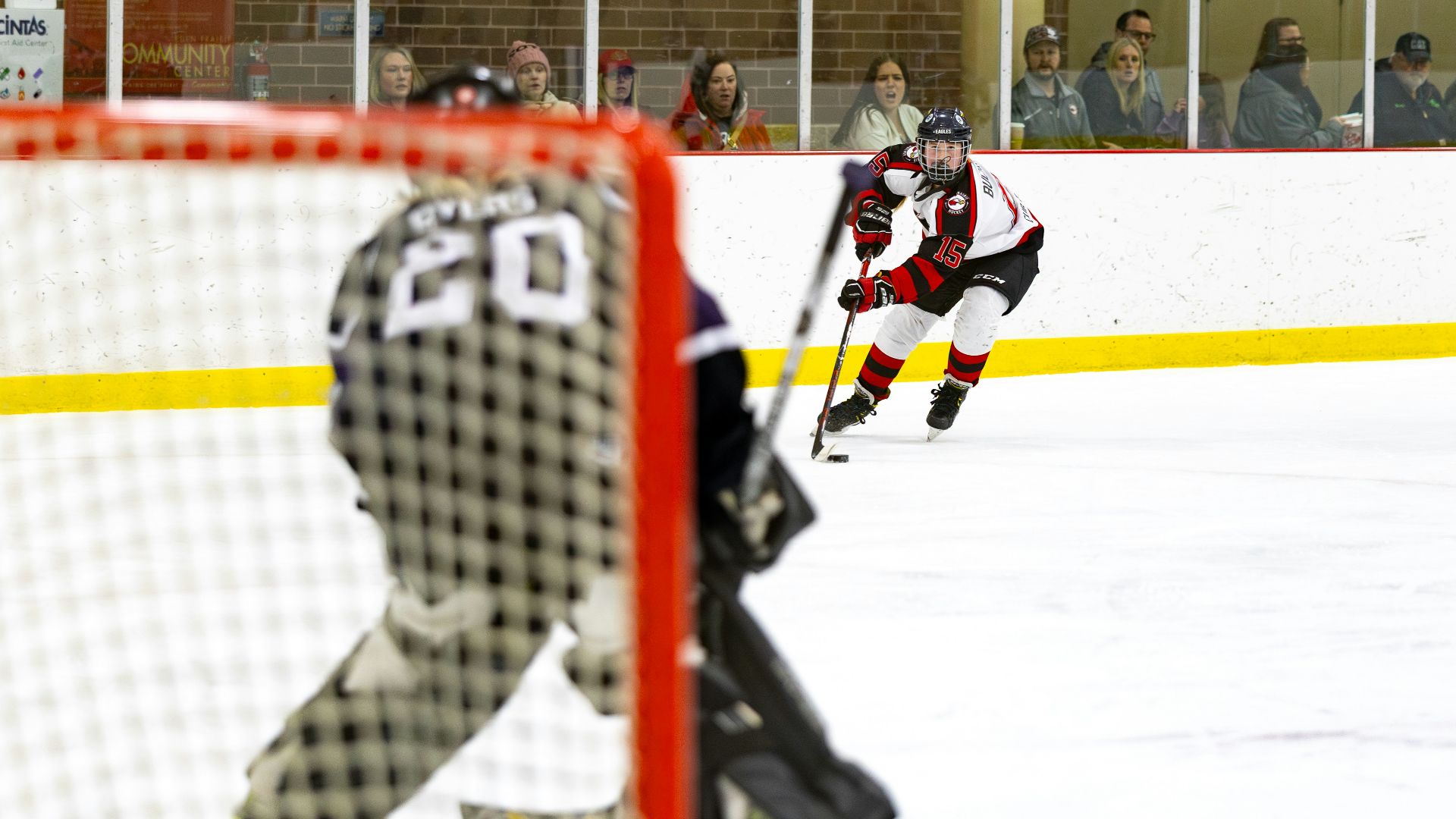 a group of people playing a game of ice hockey