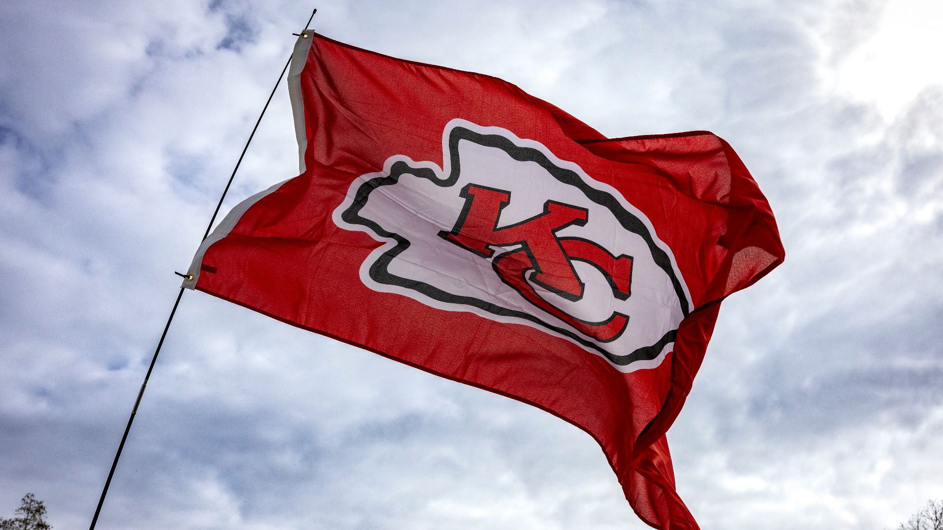 a kansas chiefs flag flying in front of a building
