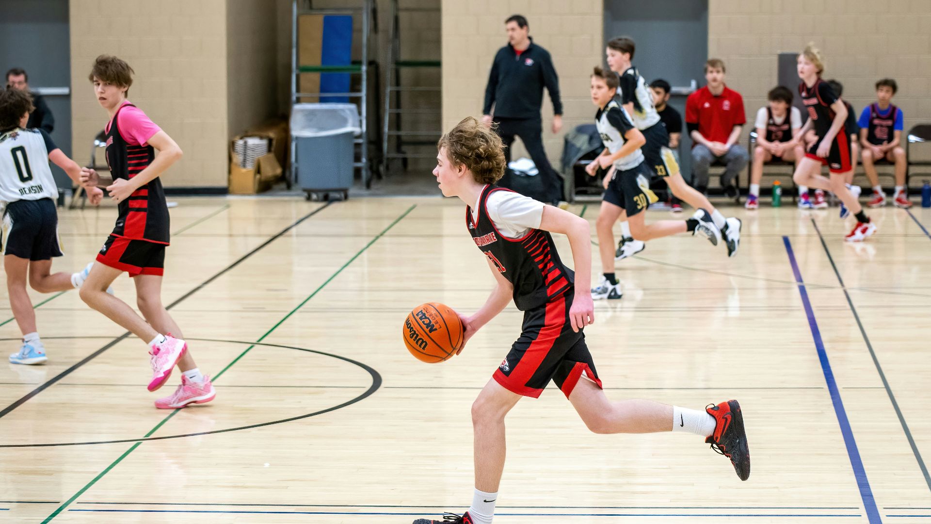 a group of young people playing a game of basketball