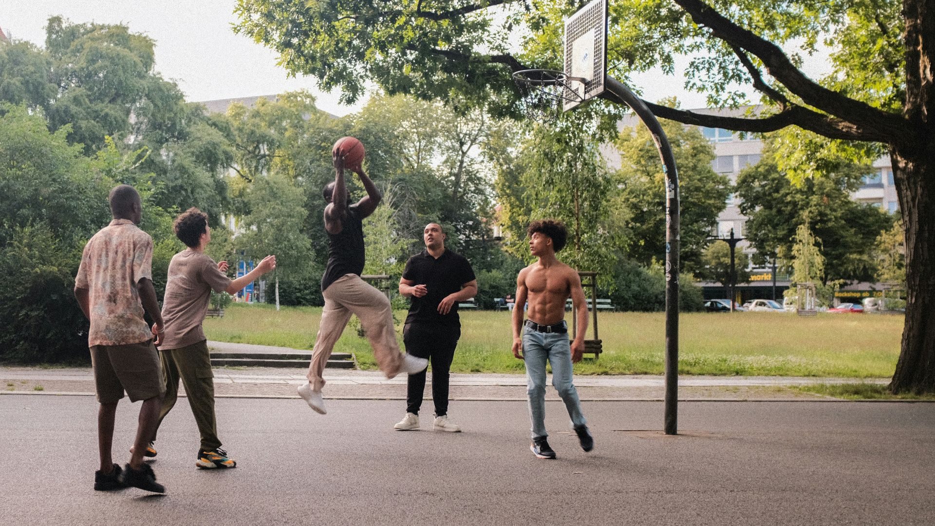 A group of young men playing a game of basketball