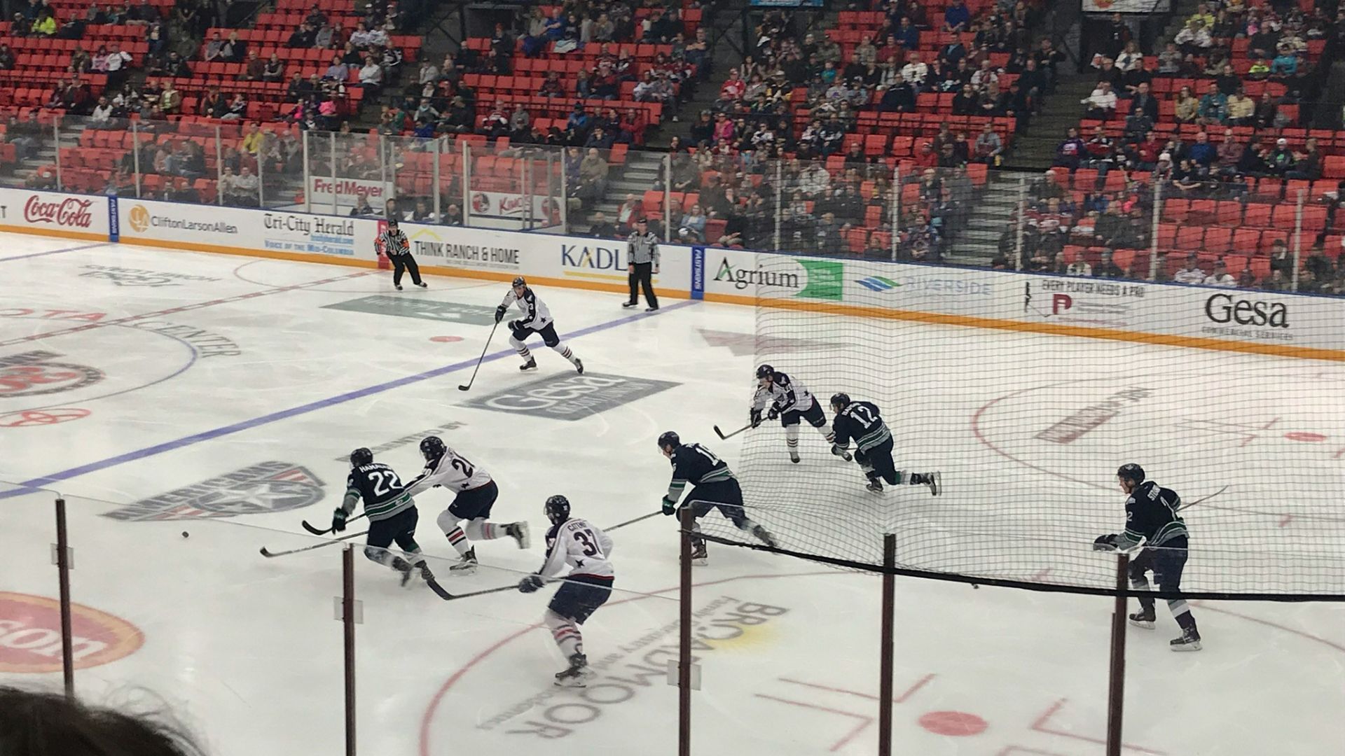 people playing ice hockey at the arena