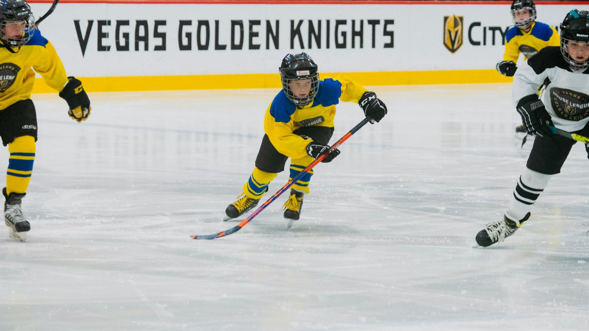 a group of young men playing a game of ice hockey