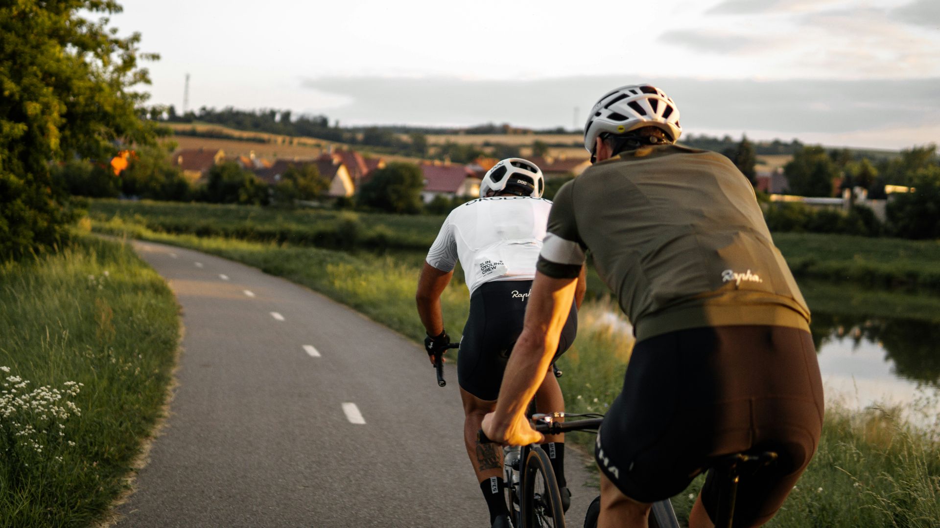 man in brown t-shirt riding on bicycle on road during daytime