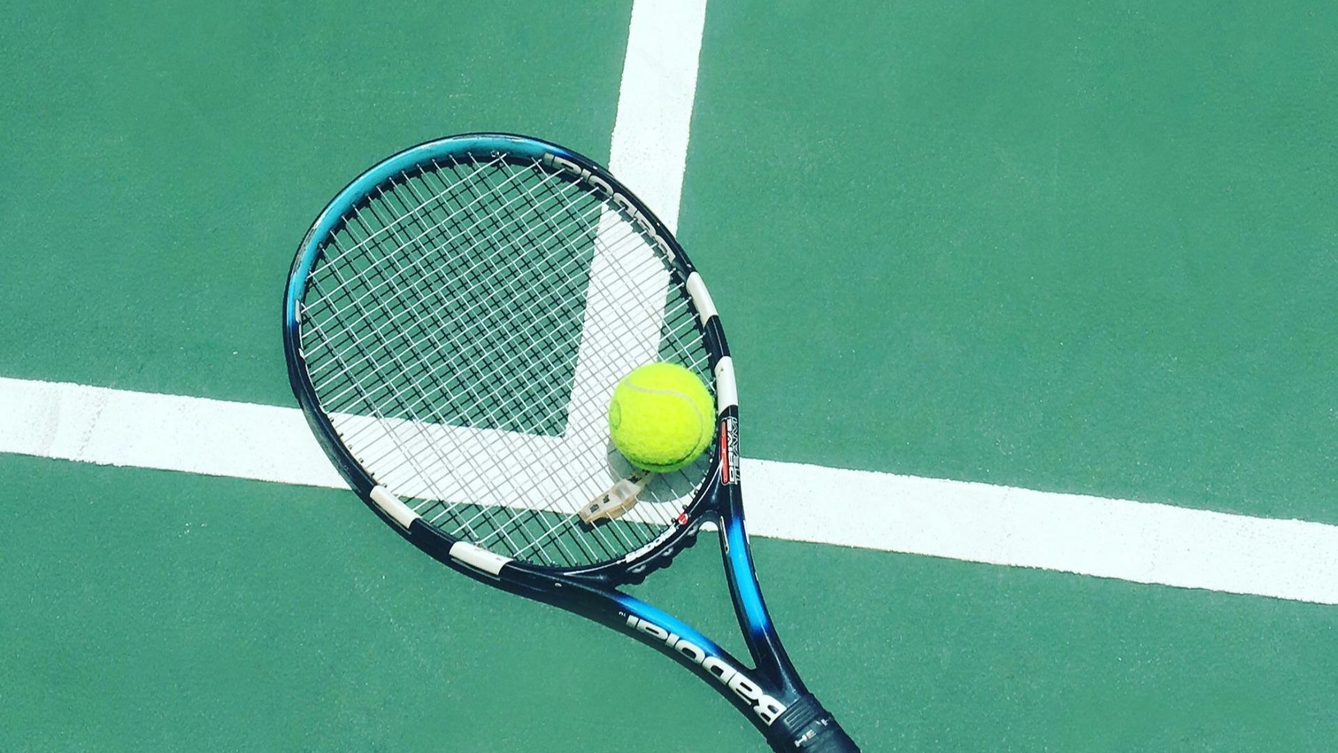 tennis racket and ball on field