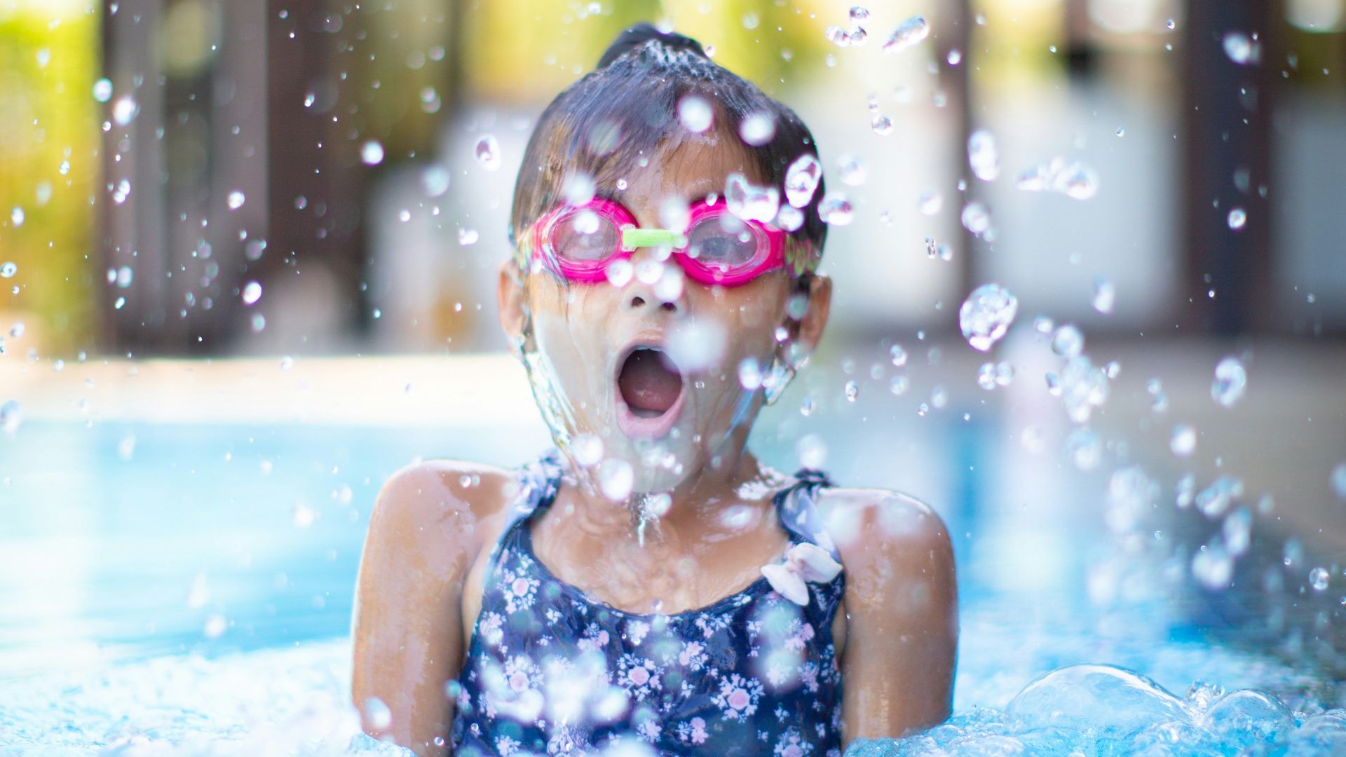 girl swims on swimming pool