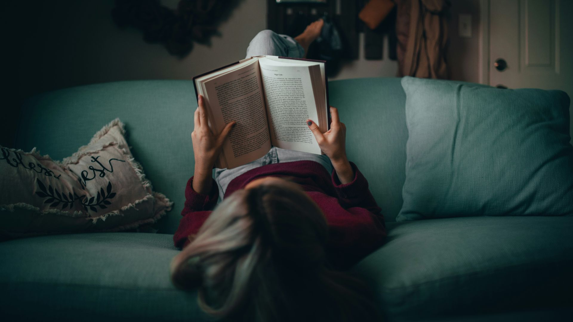 woman in red shirt reading book