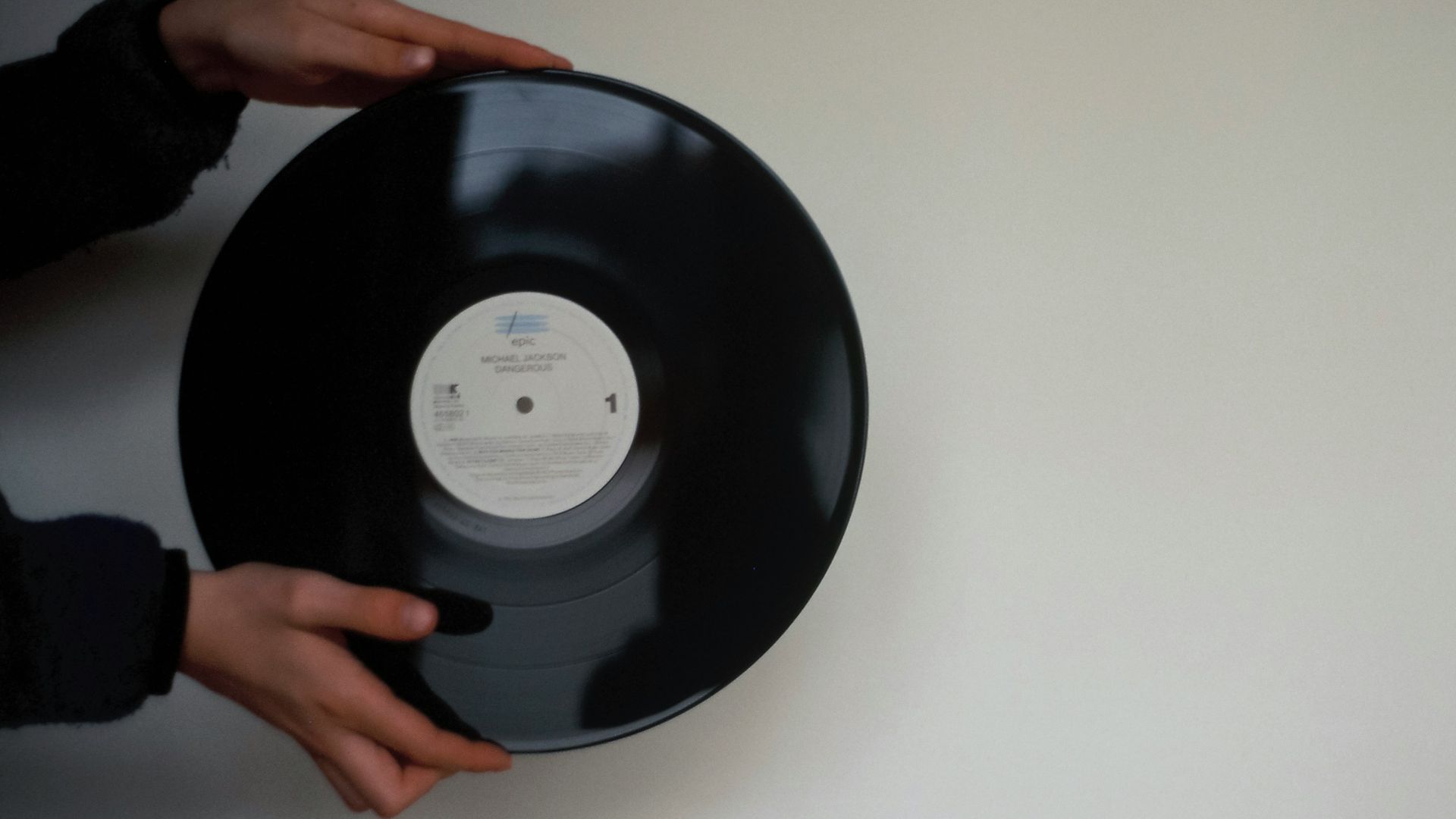 a person holding a black object