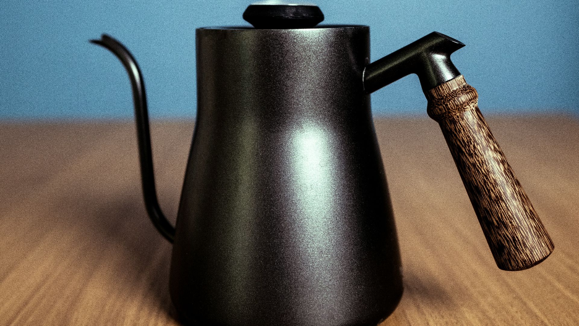 black kettle on brown wooden table
