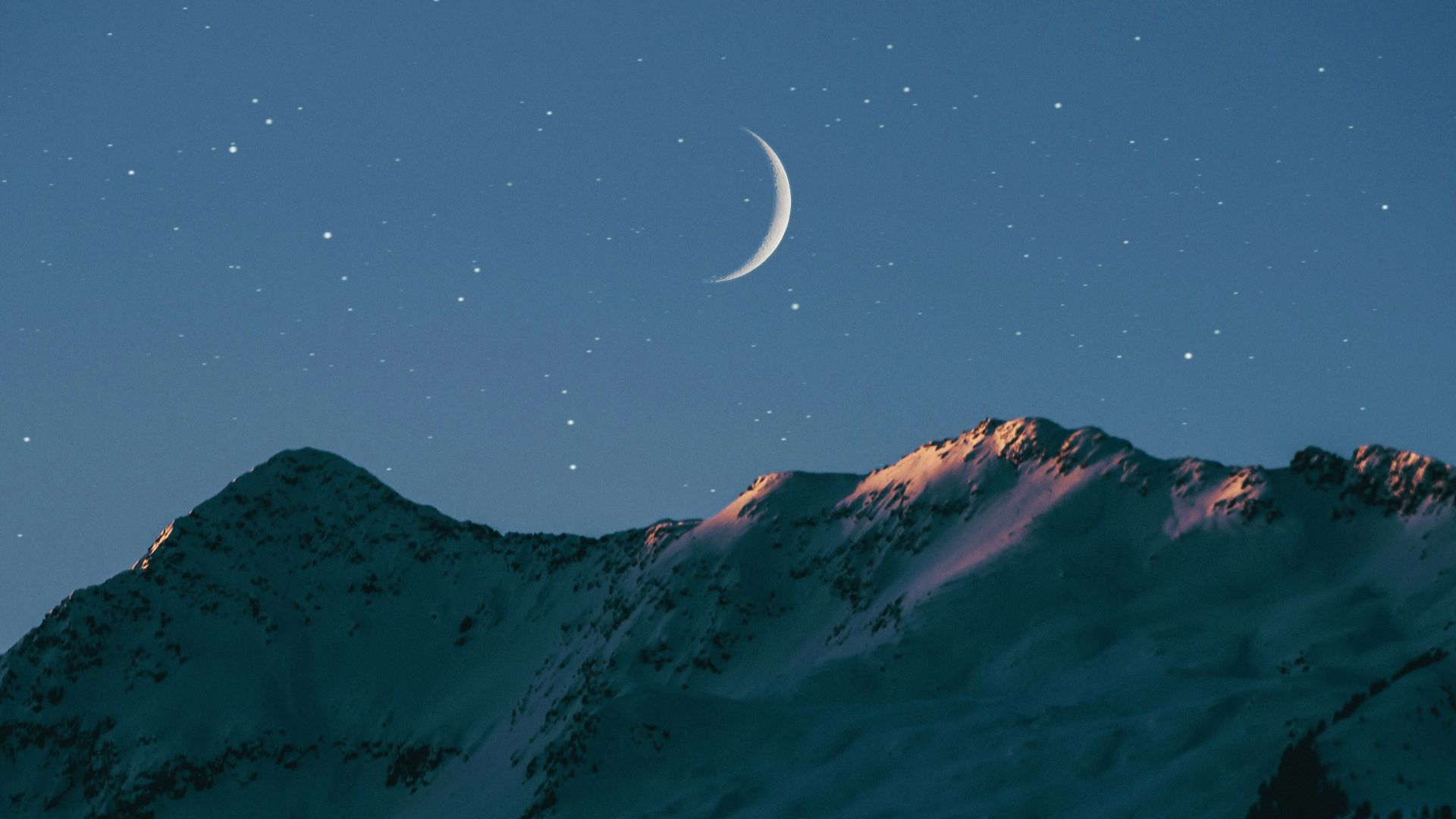 crescent moon above mountain