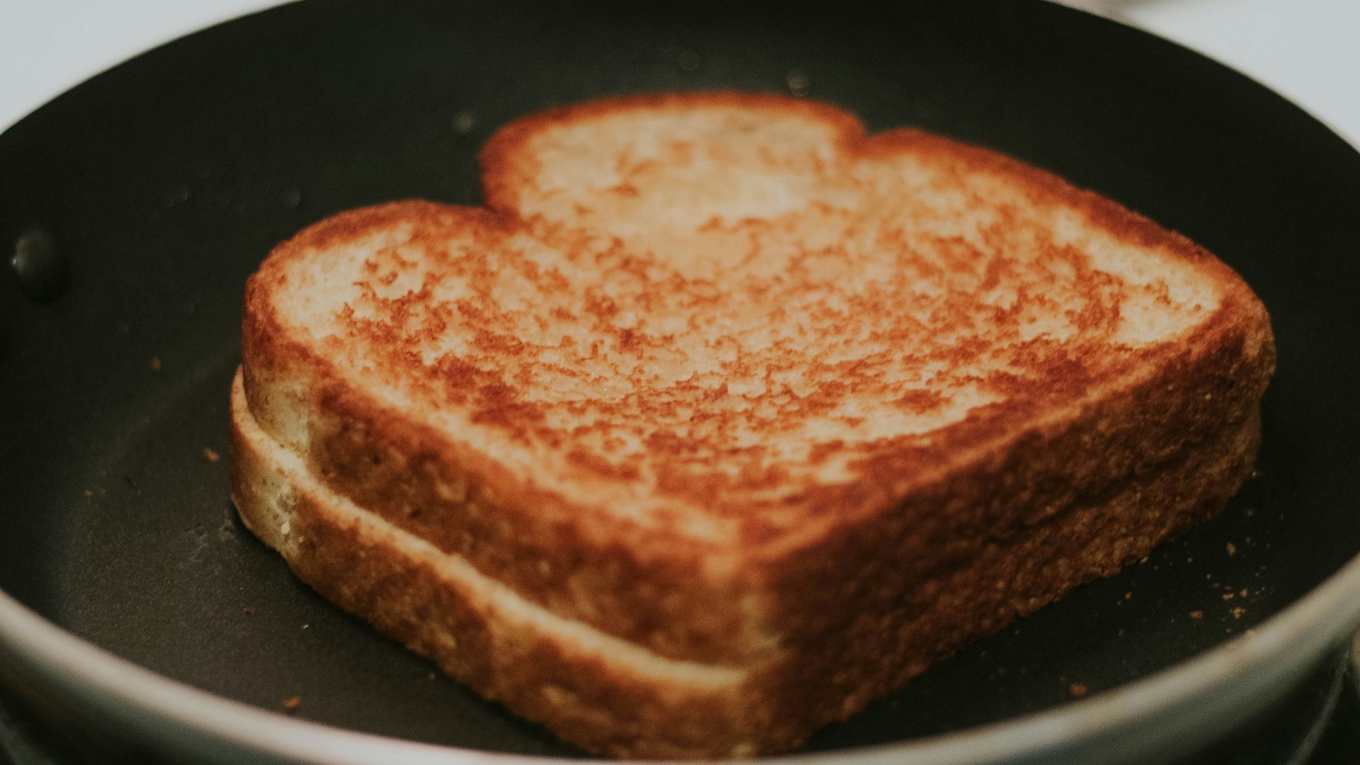 a toasted sandwich in a frying pan on a stove
