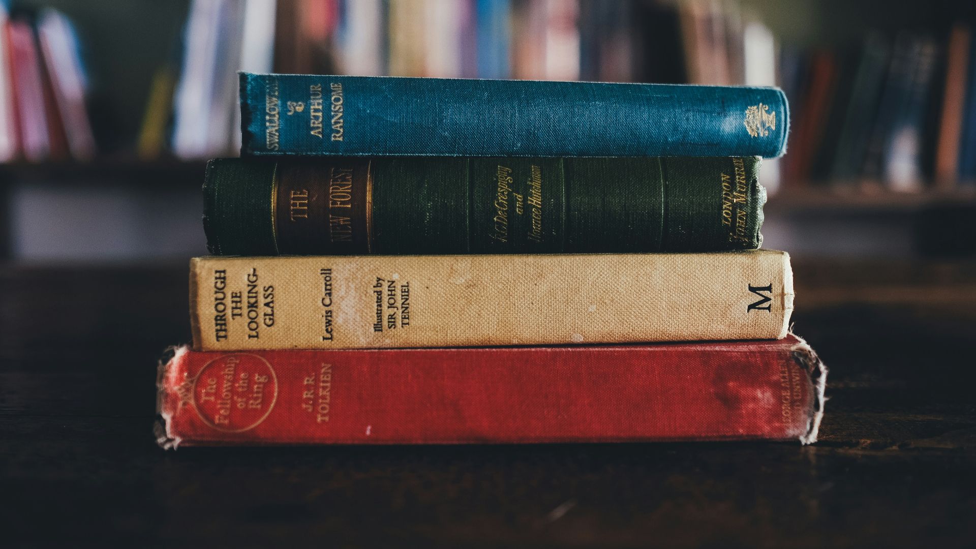 four assorted reading books on brown surface