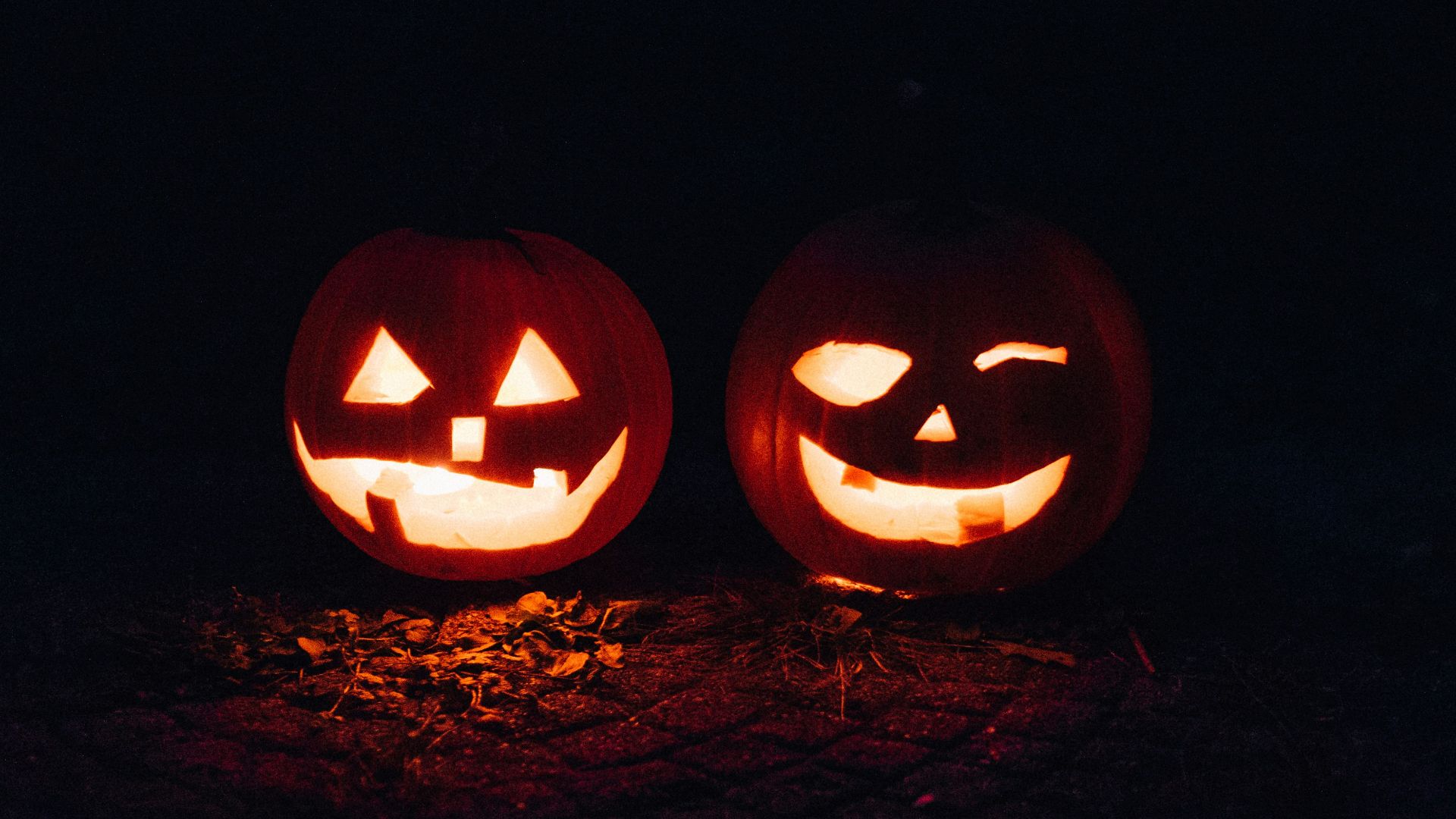 two lighted jack-o-lanterns during night time