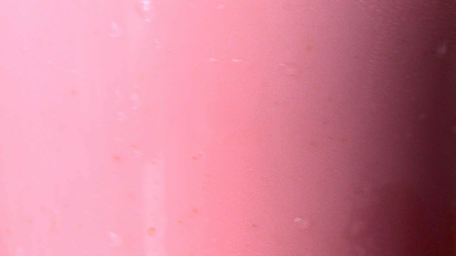 pink liquid in clear plastic cup