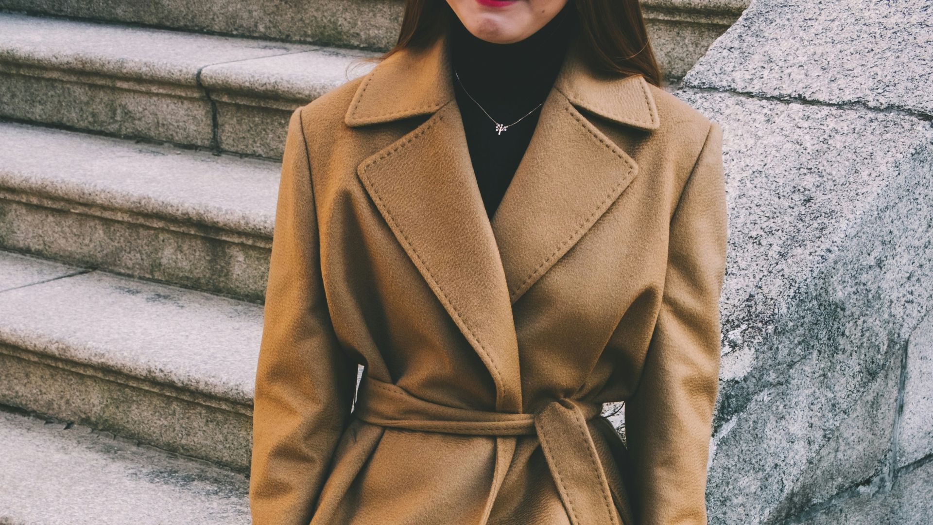 woman wearing brown notched lapel coat