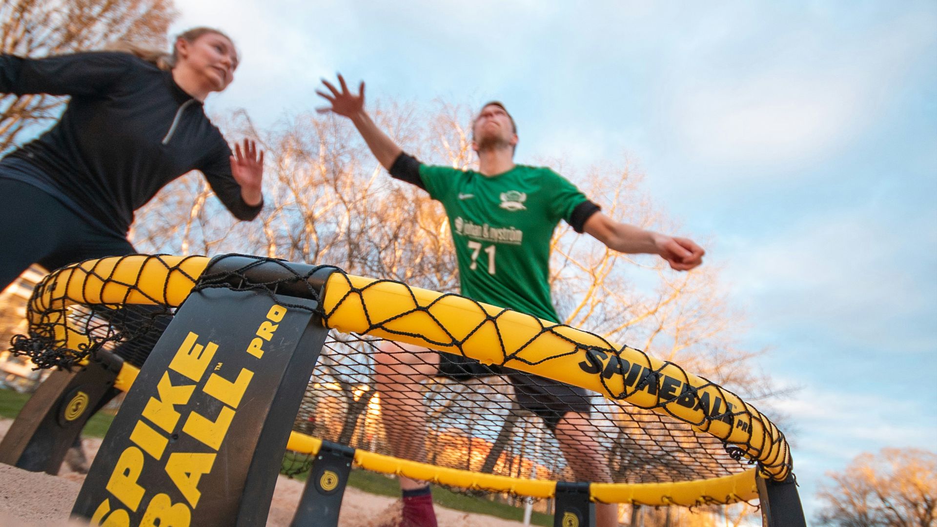 boy in red and white nike soccer jersey shirt standing on brown sand during daytime