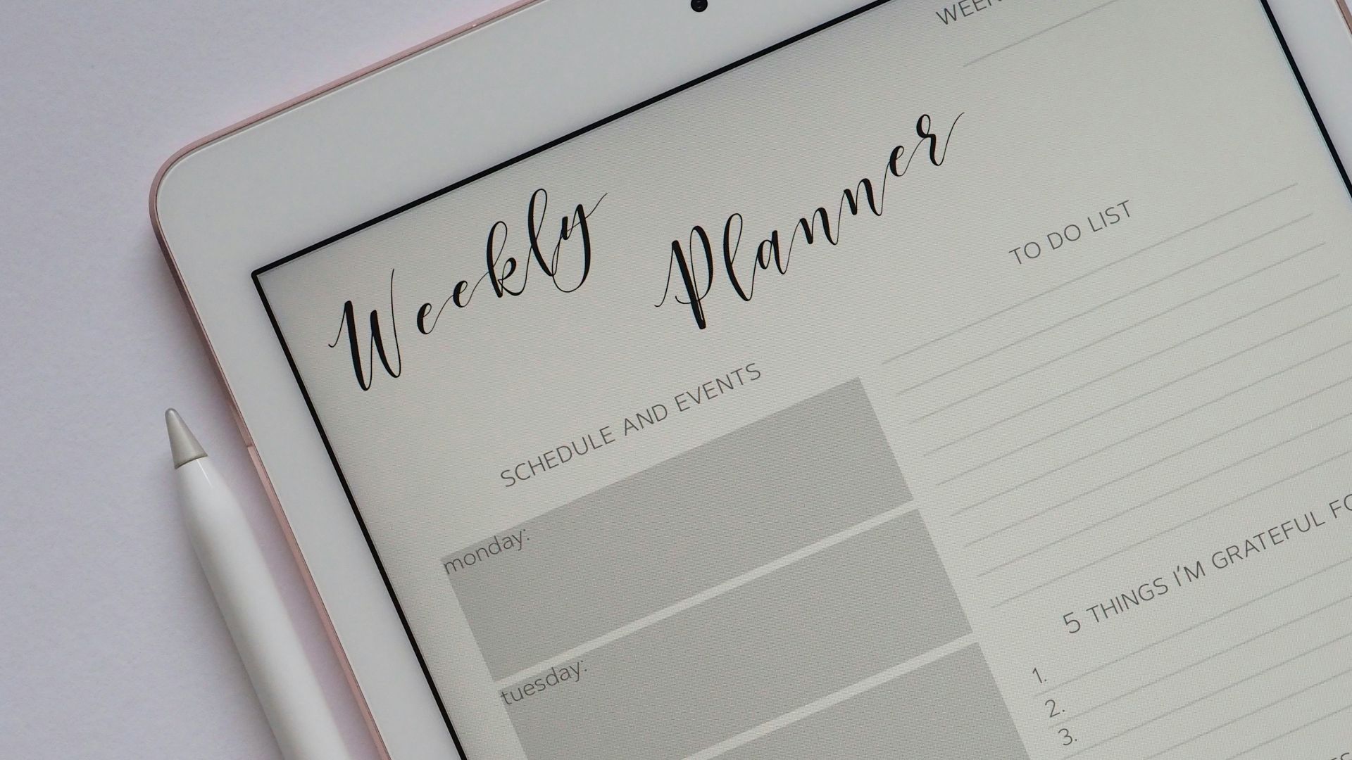 flat lay photography of turned-on silver iPad beside Apple Pencil